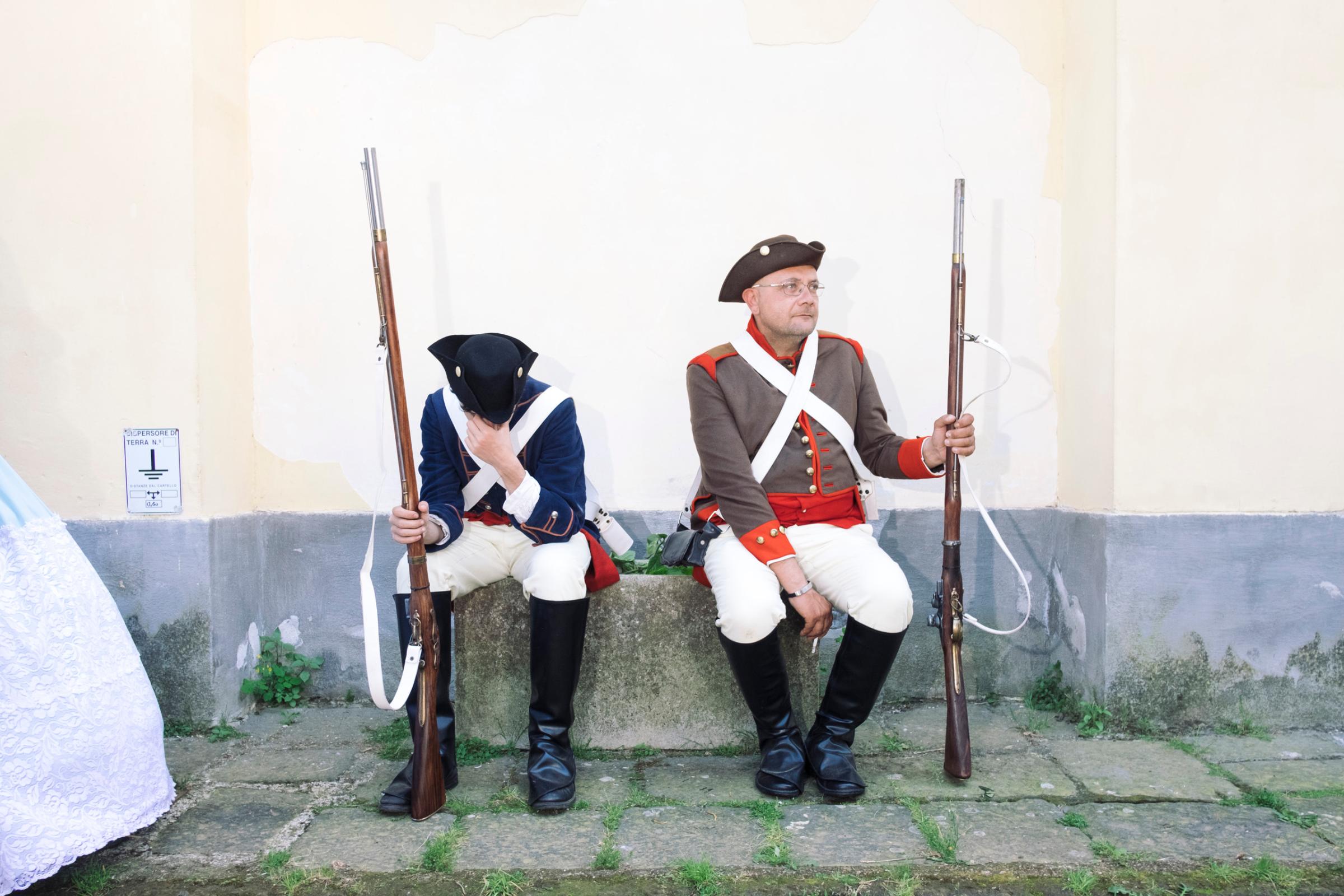 Soldiers belonging to the honor guards of the "III Reggimento Fanteria di Linea Principe" are resting during an historical parade at the Royal Palace of Capodimonte in Naples, April, 2016.