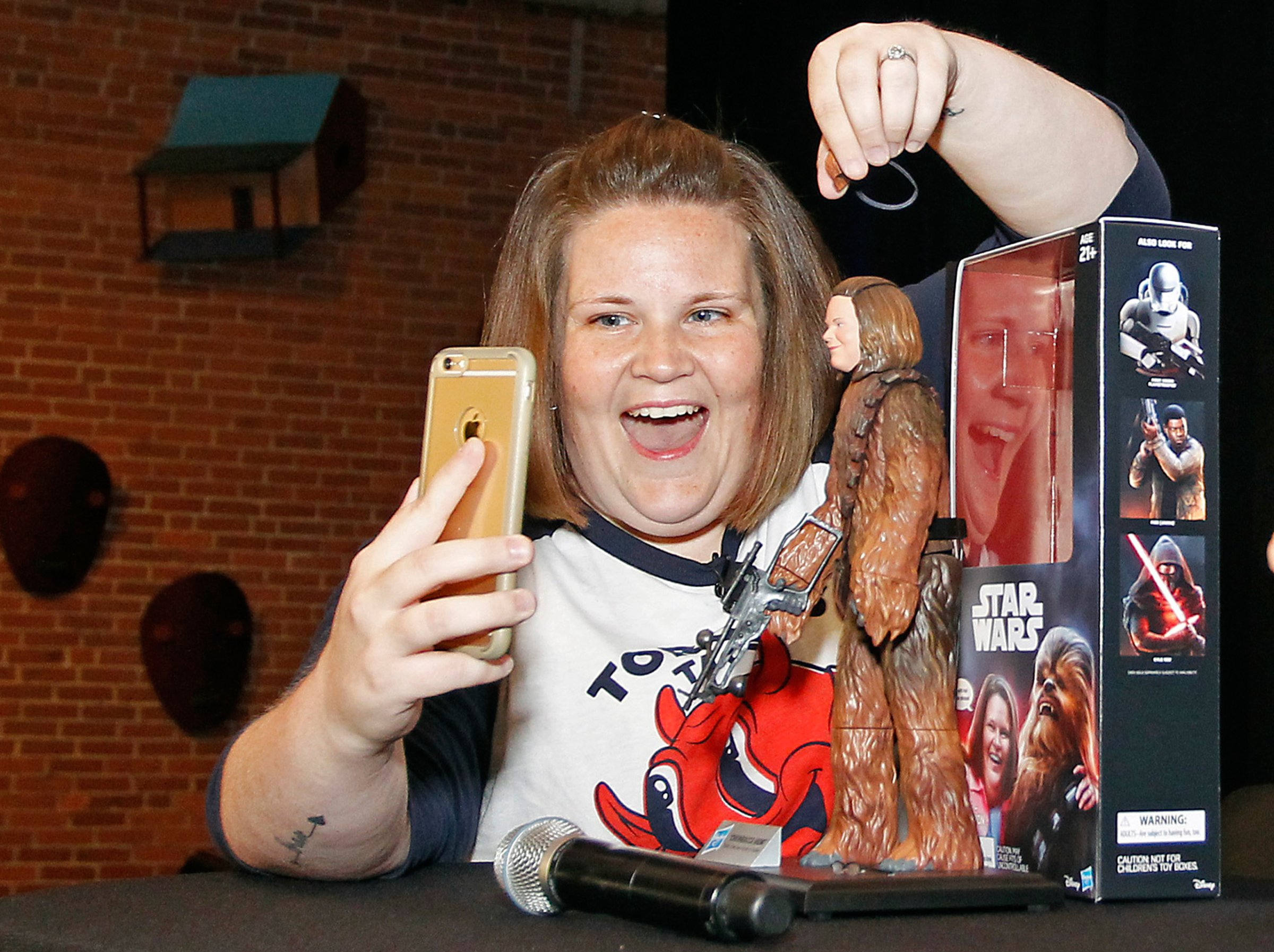 Candace Payne, also known as Chewbacca Mom, streams a Facebook Live video with her custom Chewbacca Mom action figure during a meet and greet at Hasbro HQ in Pawtucket, R.I., on June 17, 2016.