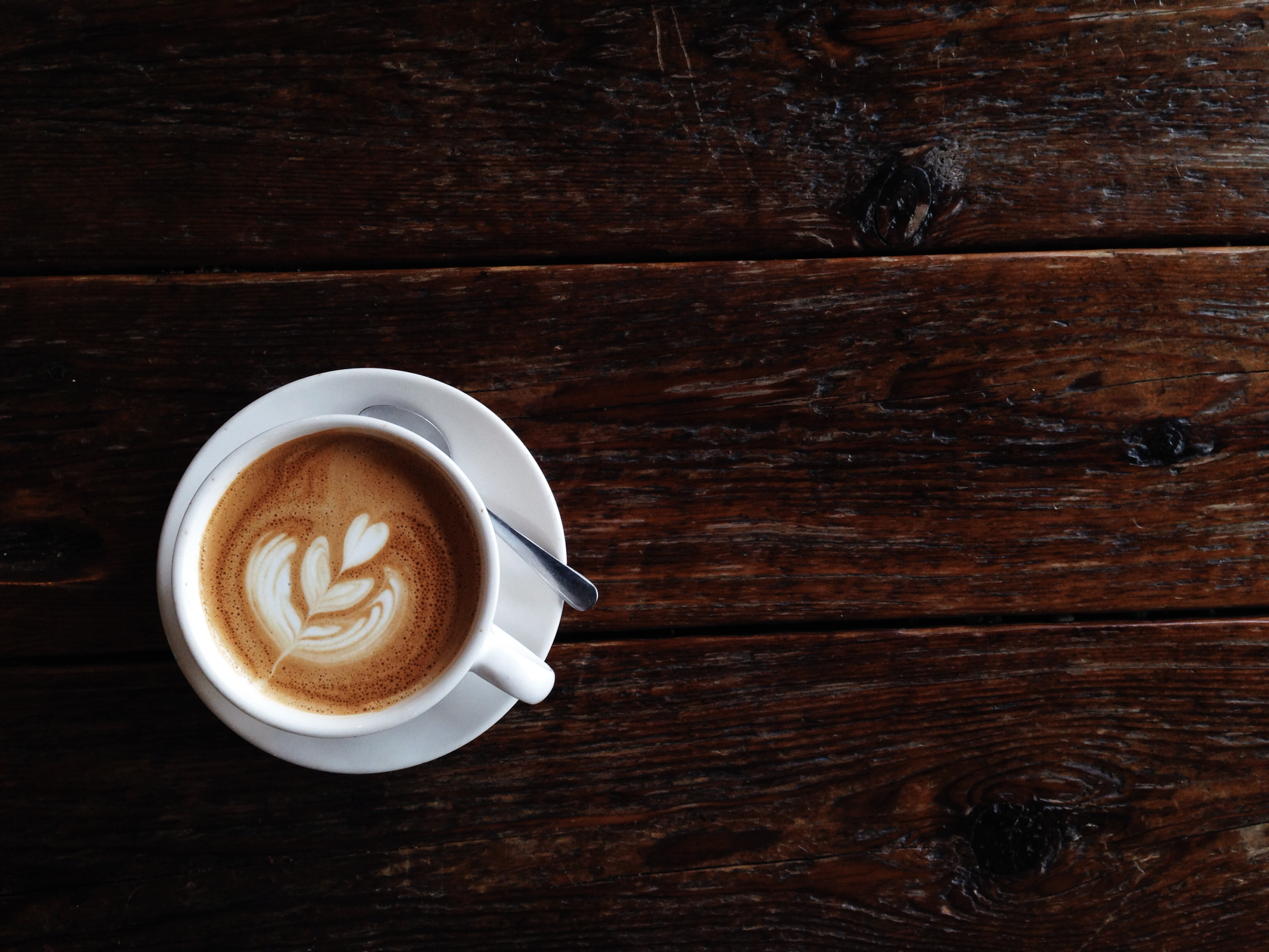 Art of producing latte (michellealbert—Getty Images/RooM RF)