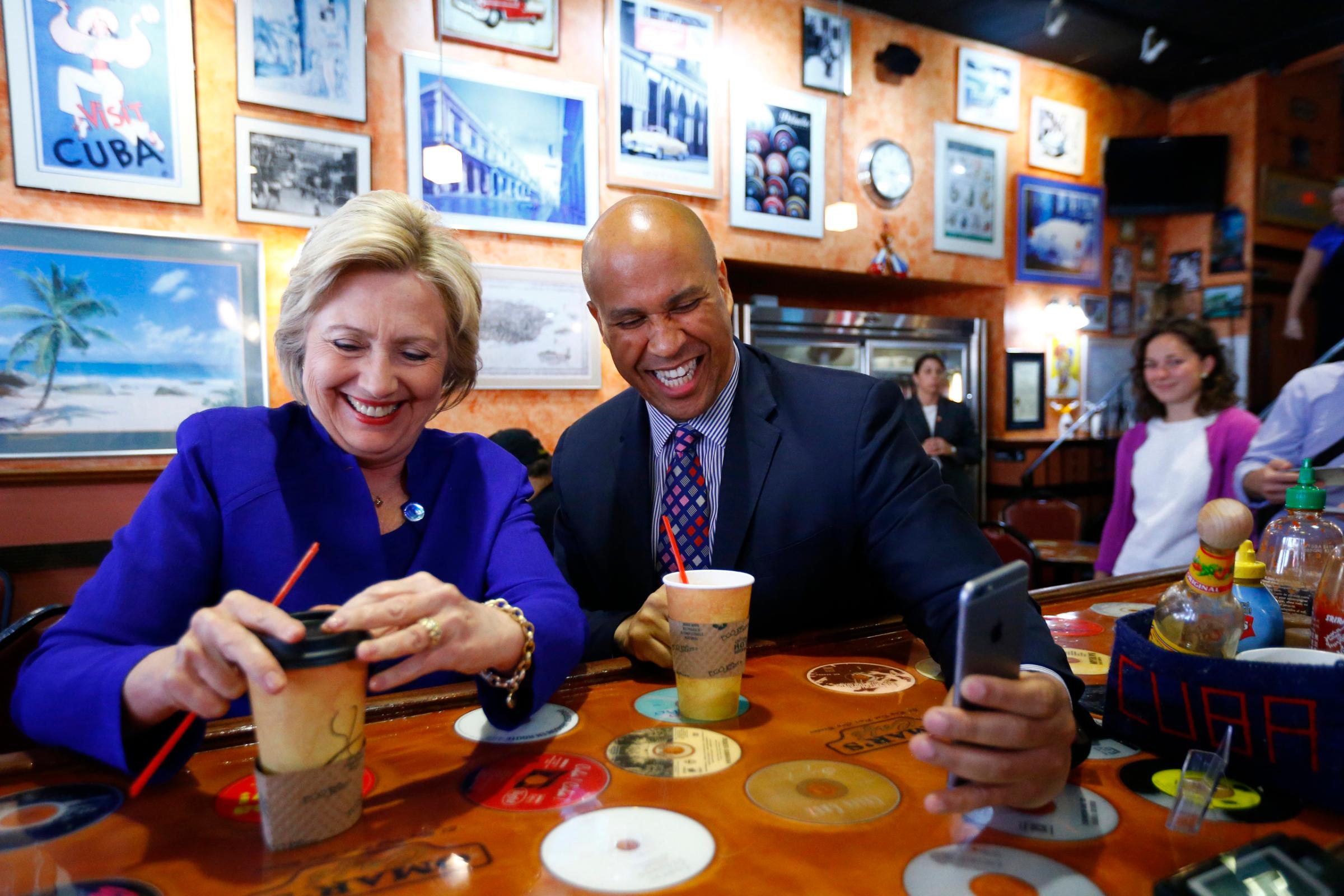 Democratic presidential candidate Hillary Clinton talks with Sen. Cory Booker at Omar's Cafe while campaigning, , in Newark on June 1, 2016.