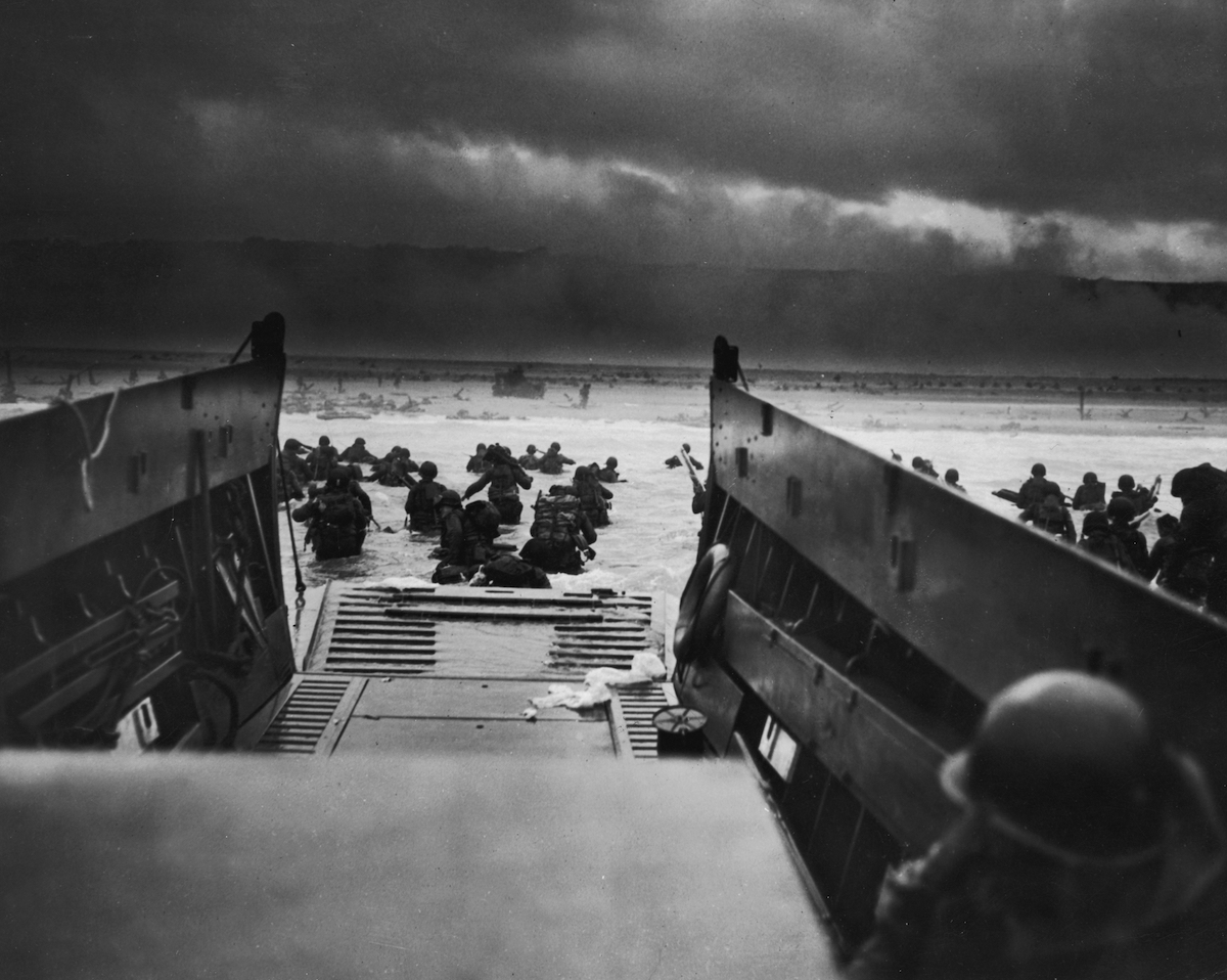 A view from inside one of the landing craft after US troops hit the water during the Allied D-Day invasion of Normandy, France. The US troops on the shore are lying flat under German machine gun resistance. (Robert Sargent—Getty Images)