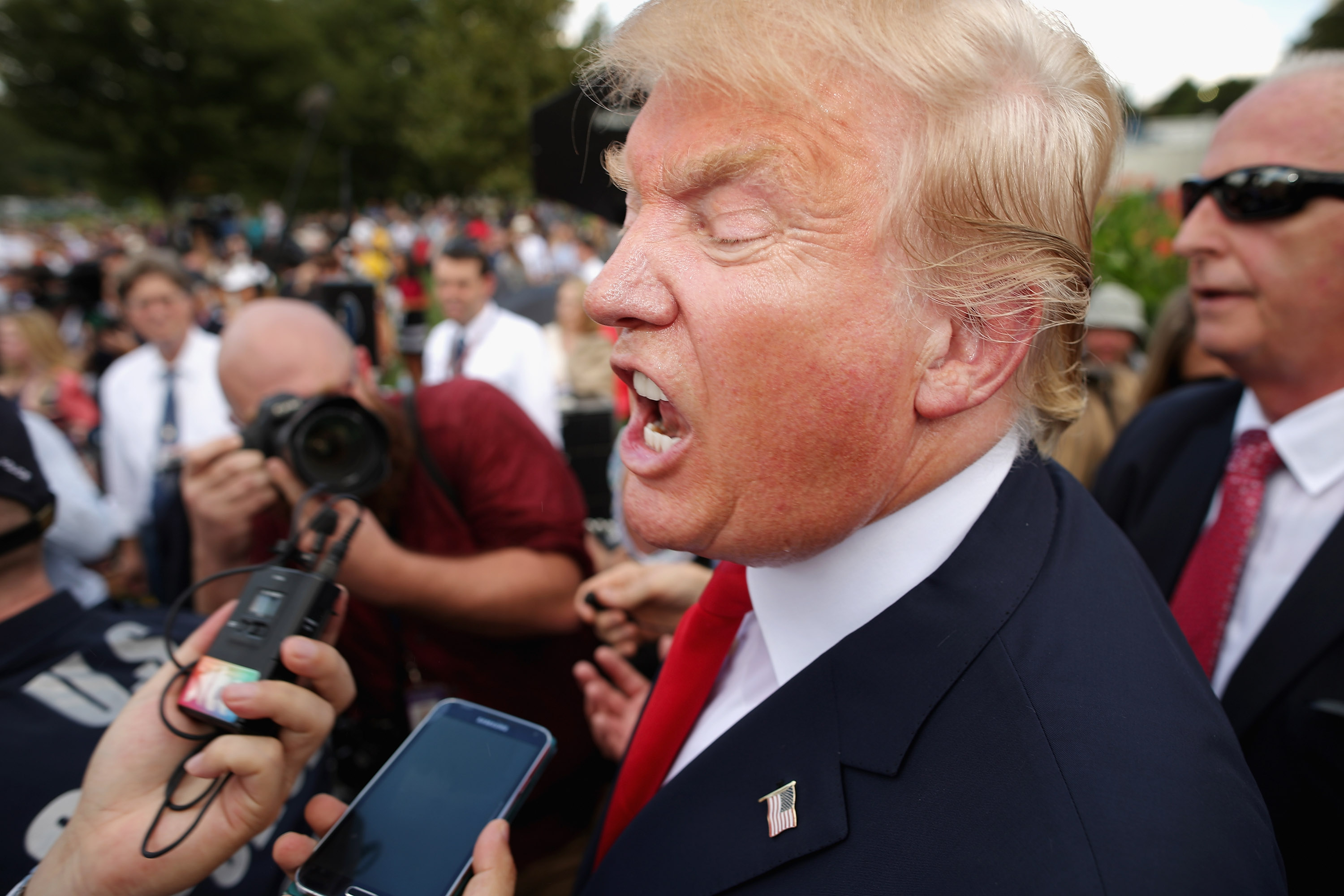 Republican presidential candidate Donald Trump (2nd L) talks with journalists during a rally against the Iran nuclear deal on the West Lawn of the U.S. Capitol September 9, 2015 in Washington, DC.