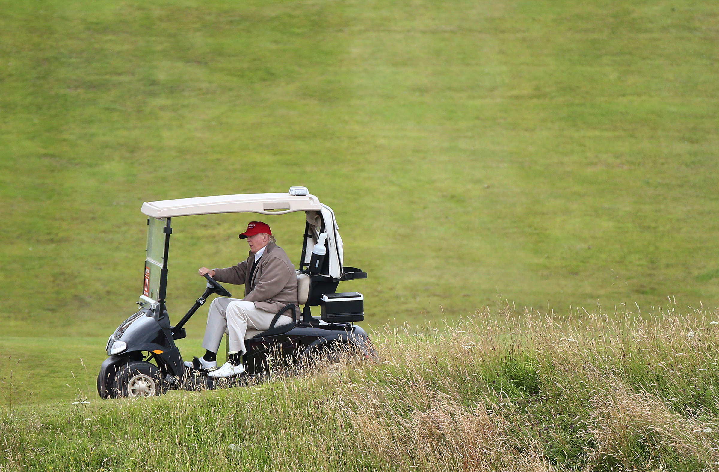 Donald Trump drives his golf buggy during the second day of the 2015 Women's British Open golf championship on the Turnberry golf course in Scotland. (Scott Heppell—AP)