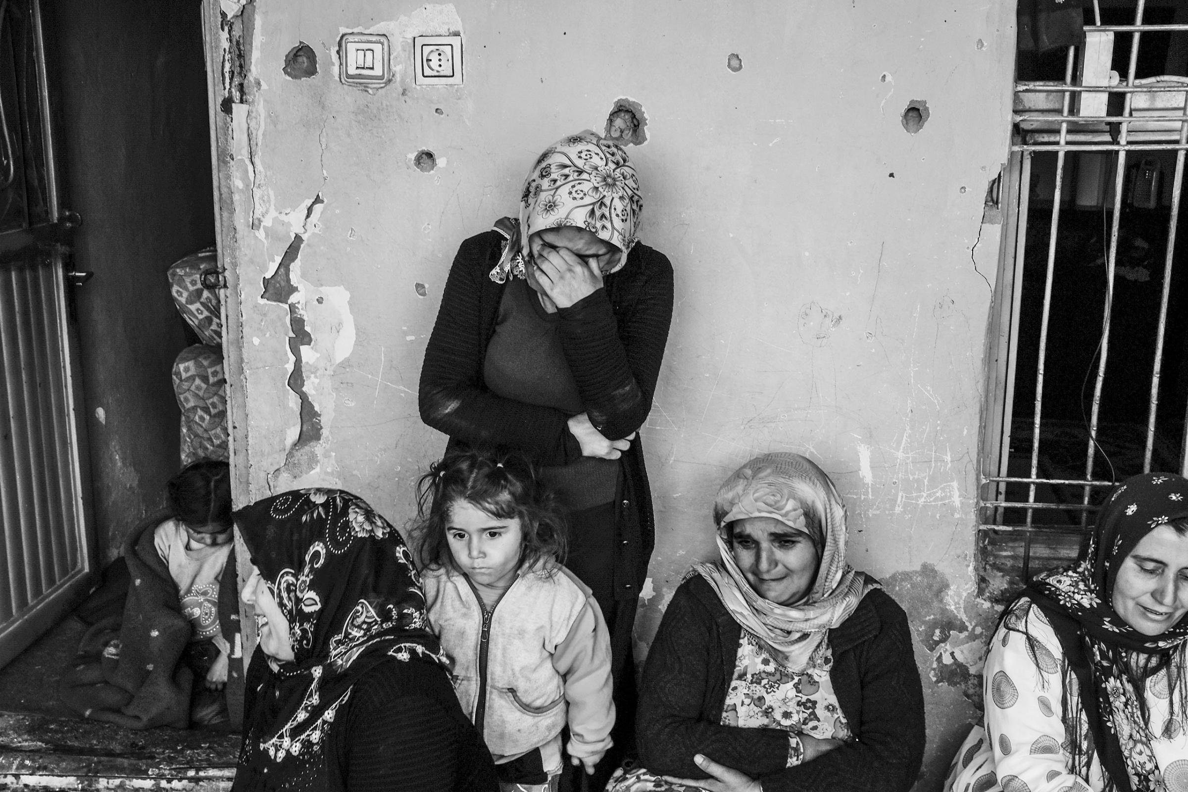 A family mourns the death of their 17-year-old son, Kasim, who was killed when the building he was in was destroyed by Turkish special forces, Cizre, Turkey, March 2016.