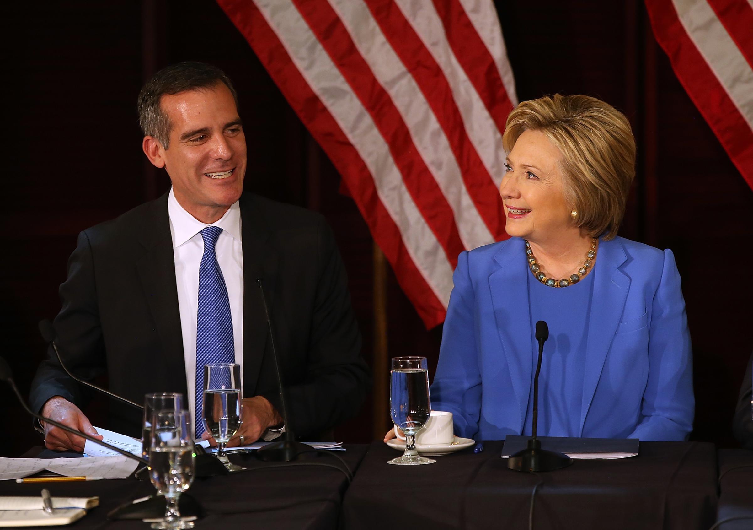 Democratic presidential candidate former Secretary of State Hillary Clinton talks with Los Angeles mayor Eric Garcetti during a roundtable discussion at the University of Southern California in Los Angeles, on March 24, 2016.