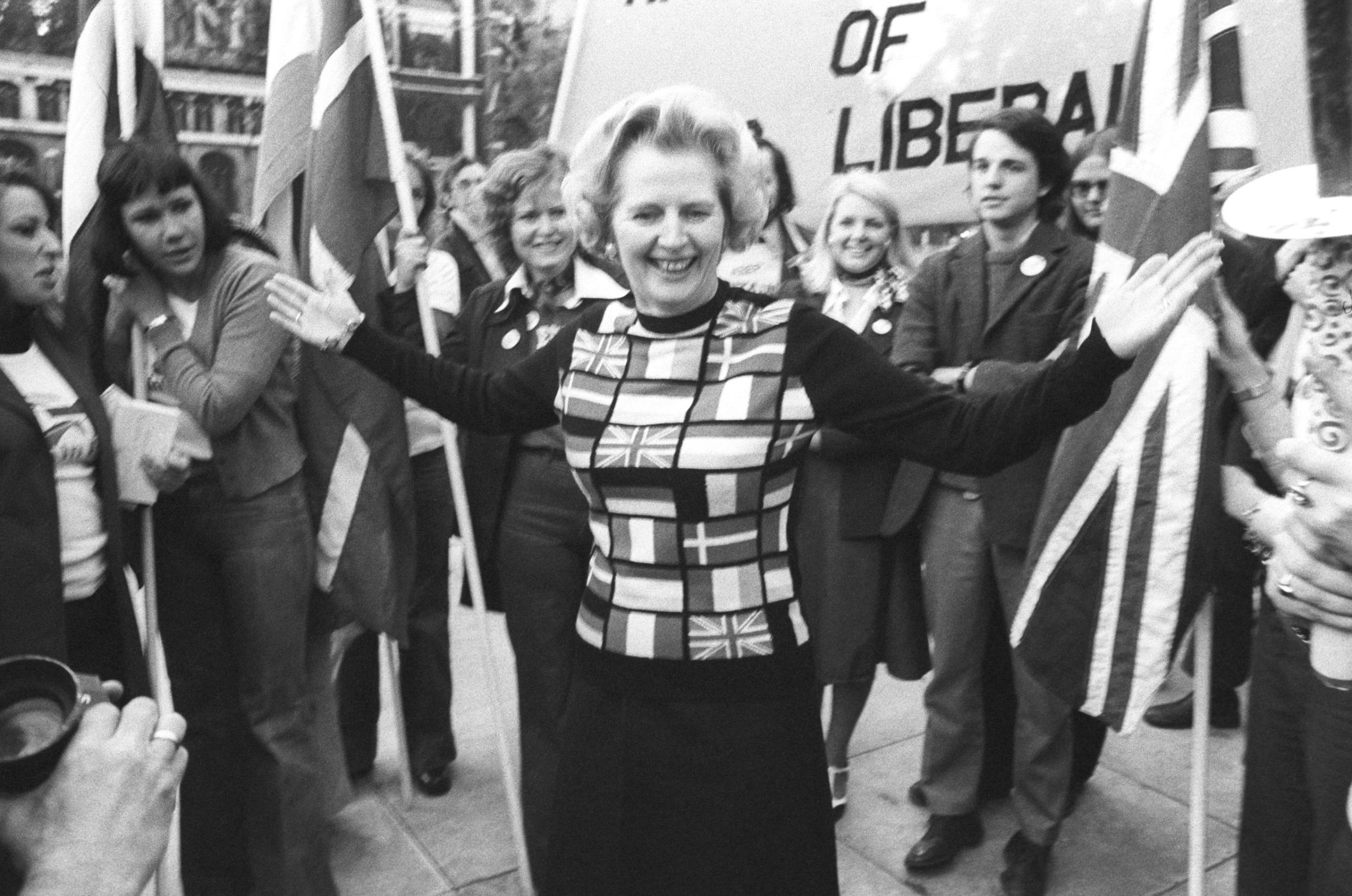 Margaret Thatcher, sporting a sweater bearing the flags of European nations, in Parliament Square during her 'Yes to Europe' campaign, 1975.