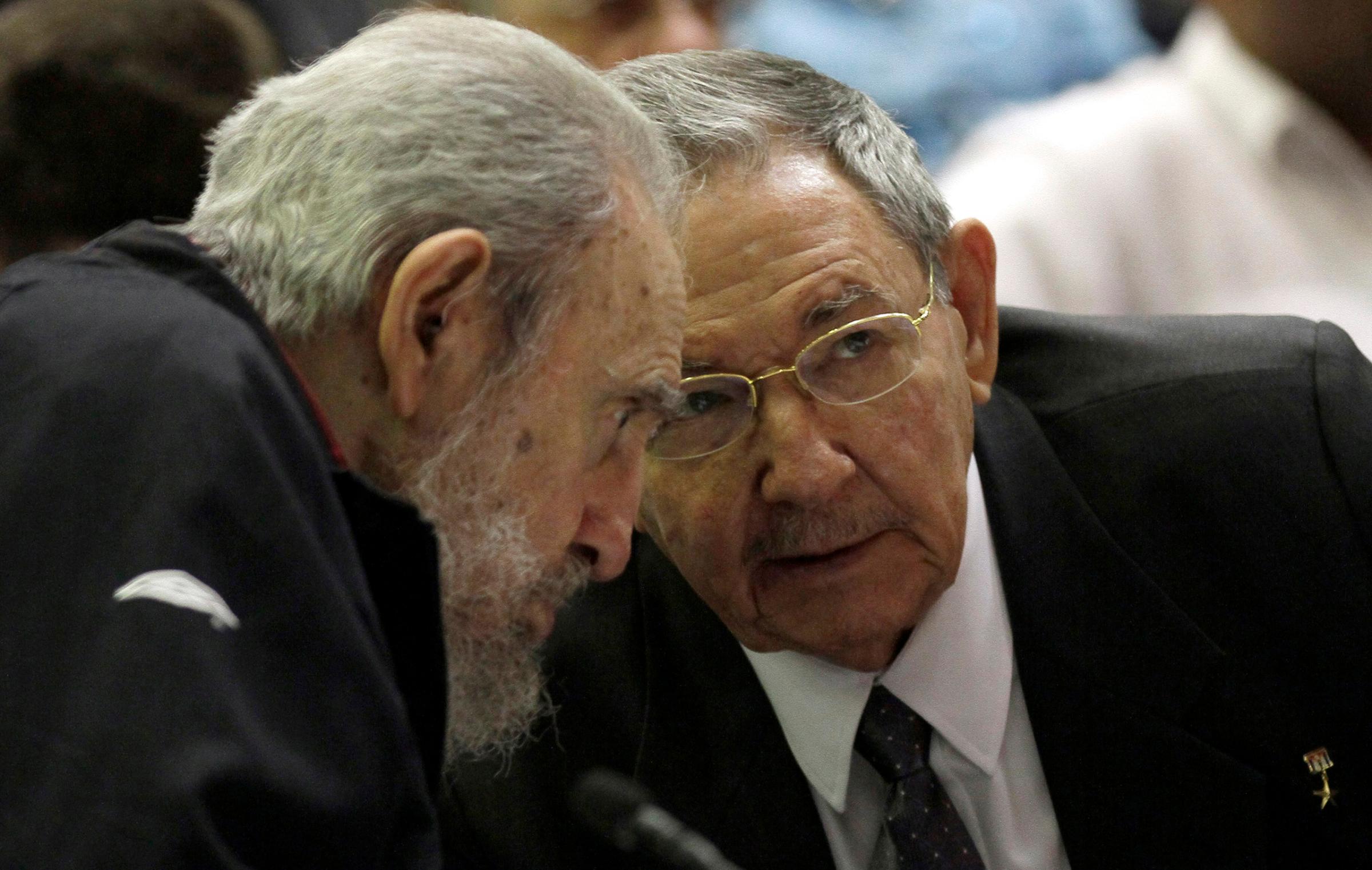 Cuban President Raul Castro speaks with his brother, Fidel Castro, during the opening session of the National Assembly in Havana on Feb. 24, 2012. Raul Castro was named to a new five-year-term as president.