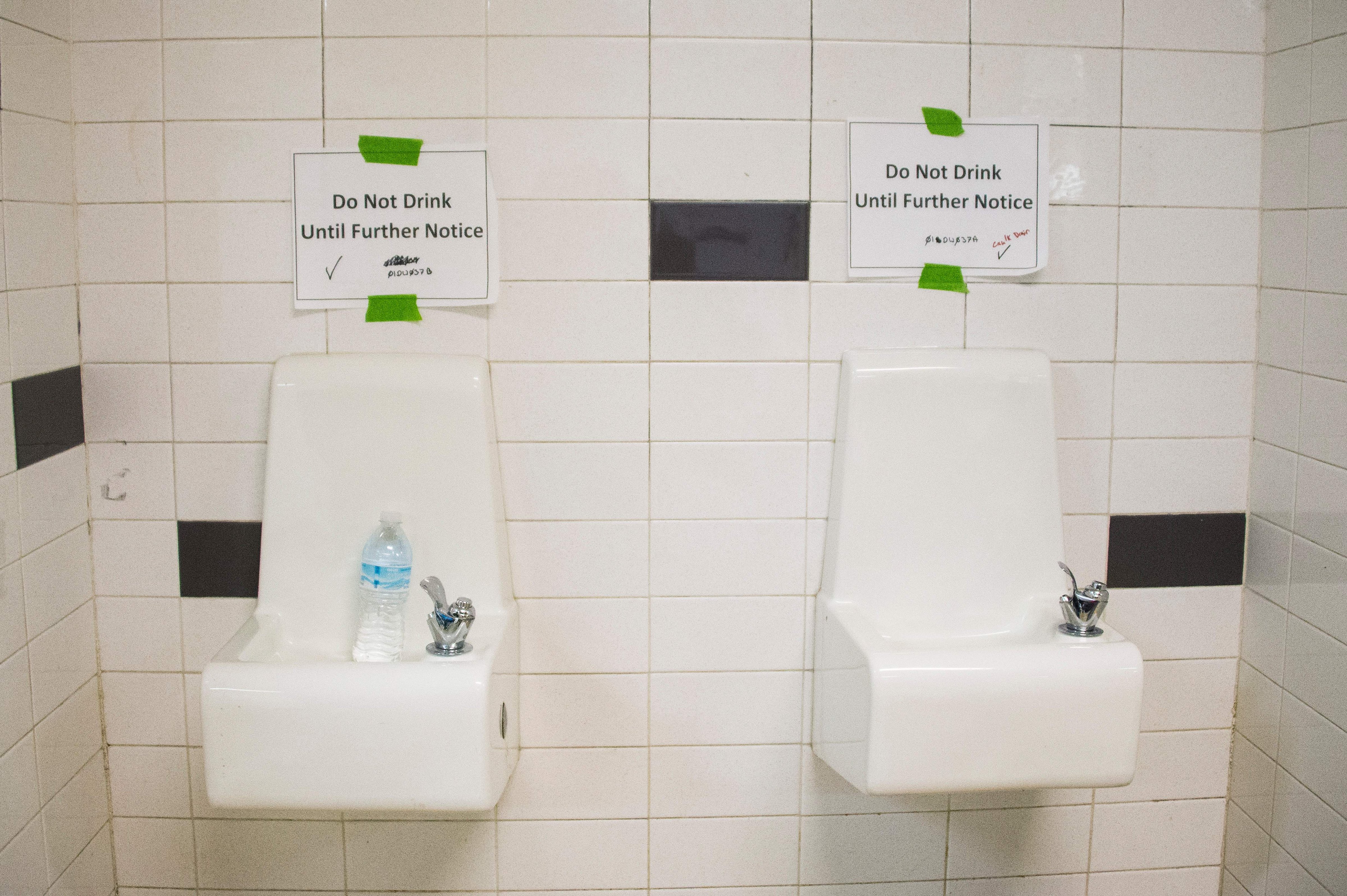 Placards posted above water fountains warn against drinking the water at Flint Northwestern High School in Flint, Michigan, May 4, 2016, where US President Barack Obama met with locals for a neighborhood roundtable on the drinking water crisis. (JIM WATSON&mdash;AFP/Getty Images)
