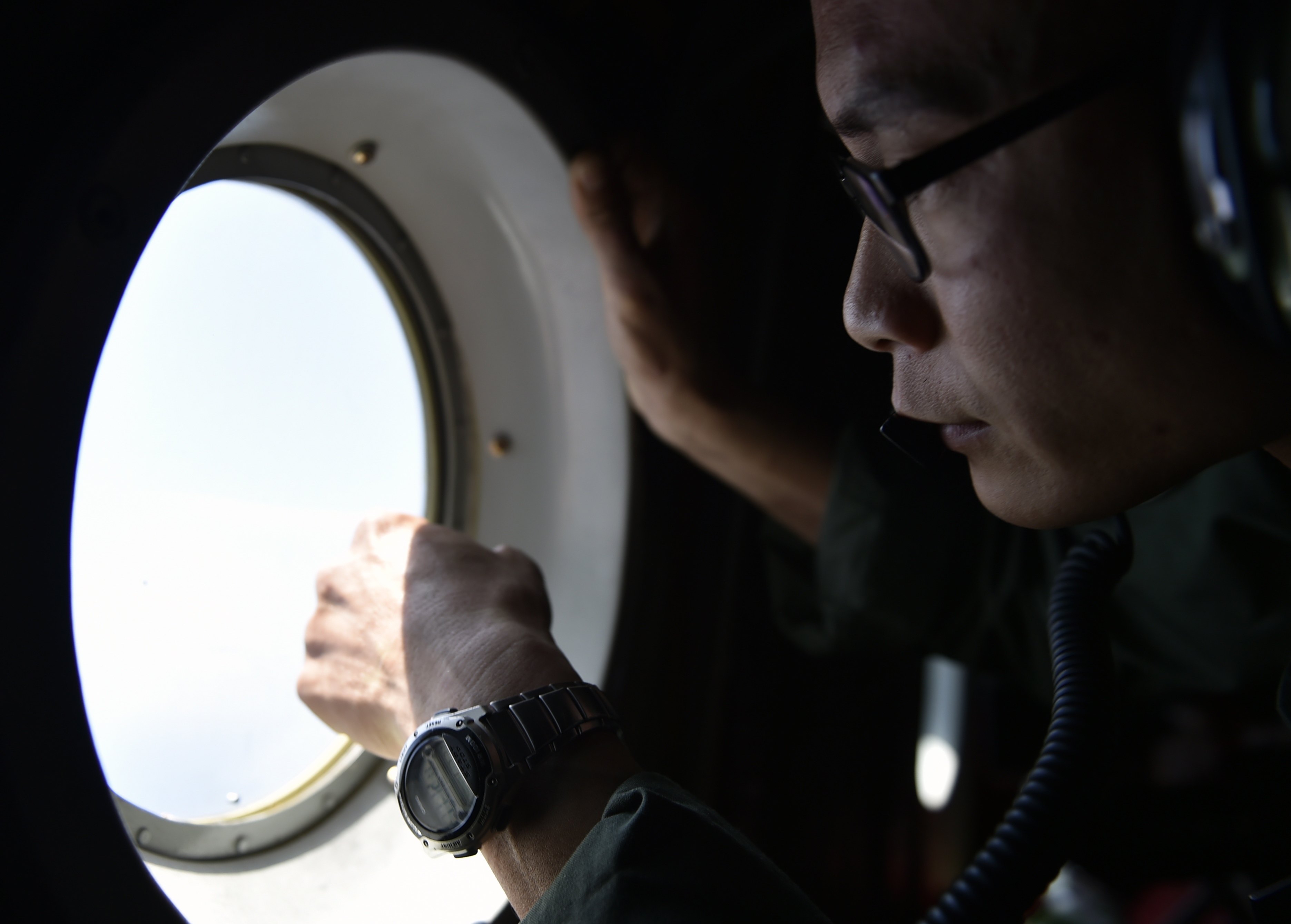 A member of the Taiwan air force looks out a window from a C-130 transport plane during a visit to take journalists to Taiping Island, part of the Spratlys Islands in the South China Sea, on March 23, 2016 (Sam Yeh—AFP/Getty Images)