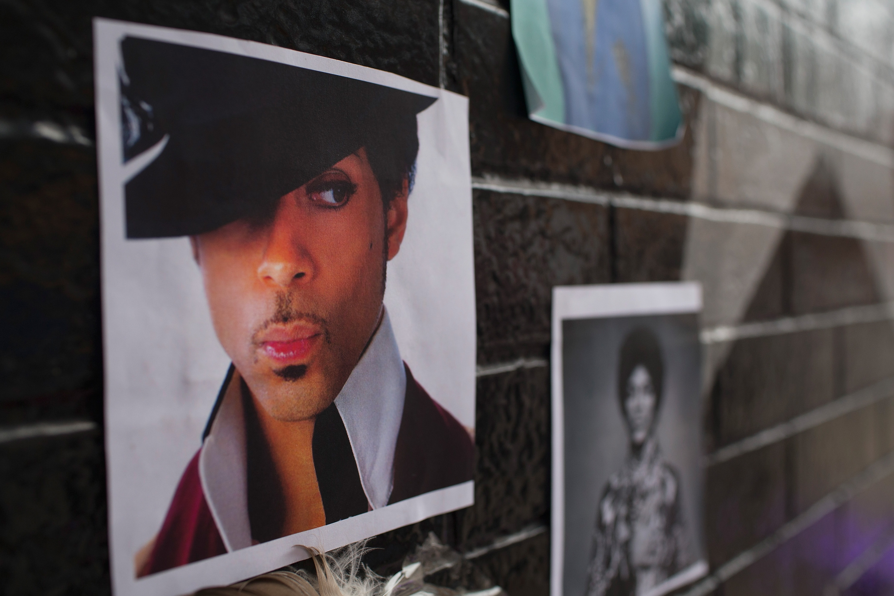 Photos of Prince are attached to the wall outside of the First Avenue nightclub where fans have created a memorial to the artist on April 22, 2016 in Minneapolis, Minnesota. (Scott Olson—Getty Images)