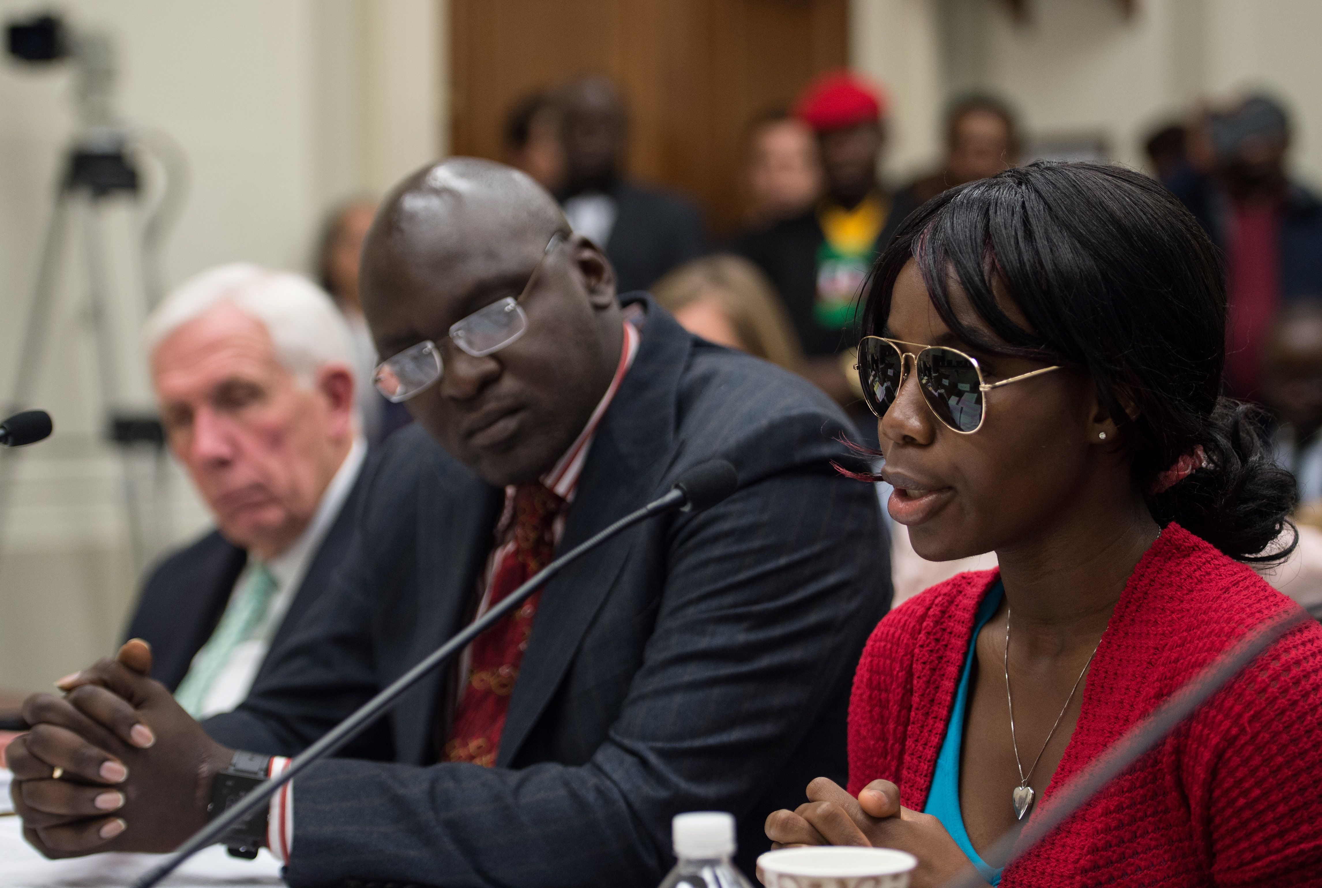 One of the Nigerian students studying in America testifies  on Capitol Hill in Washington, DC, on May 11, 2016, with Emanuel Ogebe (NICHOLAS KAMM—AFP/Getty Images)