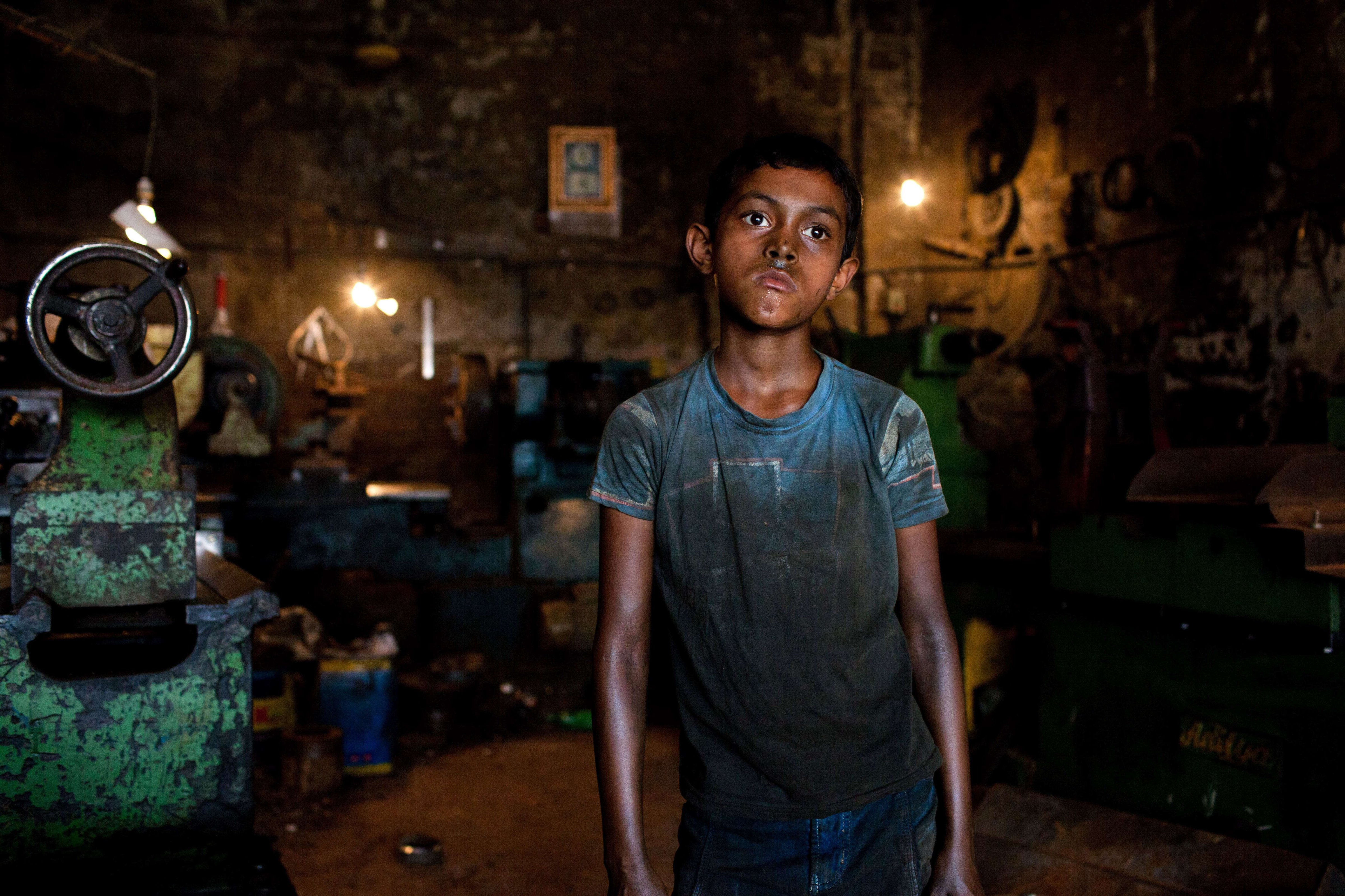 Rakib works in a parts-making shop in Dhaka, Bangladesh, on June 17, 2015. Children in Bangladesh are often employed to do hard manual labor (K M Asad—LightRocket/Getty Images)