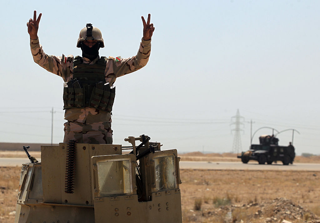 A member of the Iraqi government forces gestures as they take a position outside al-Shuhada neighborhood, south of Fallujah, during an operation to regain control of the area from the Islamic State group on June 3, 2016.
                      Iraqi forces on May 22-23 launched a vast offensive aimed at retaking the IS bastion of Fallujah, a city only 50 kilometres (30 miles) west of Baghdad that was the first to fall out of government control in 2014. / AFP / AHMAD AL-RUBAYE        (Photo credit should read AHMAD AL-RUBAYE/AFP/Getty Images) (AHMAD AL-RUBAYE&mdash;AFP/Getty Images)