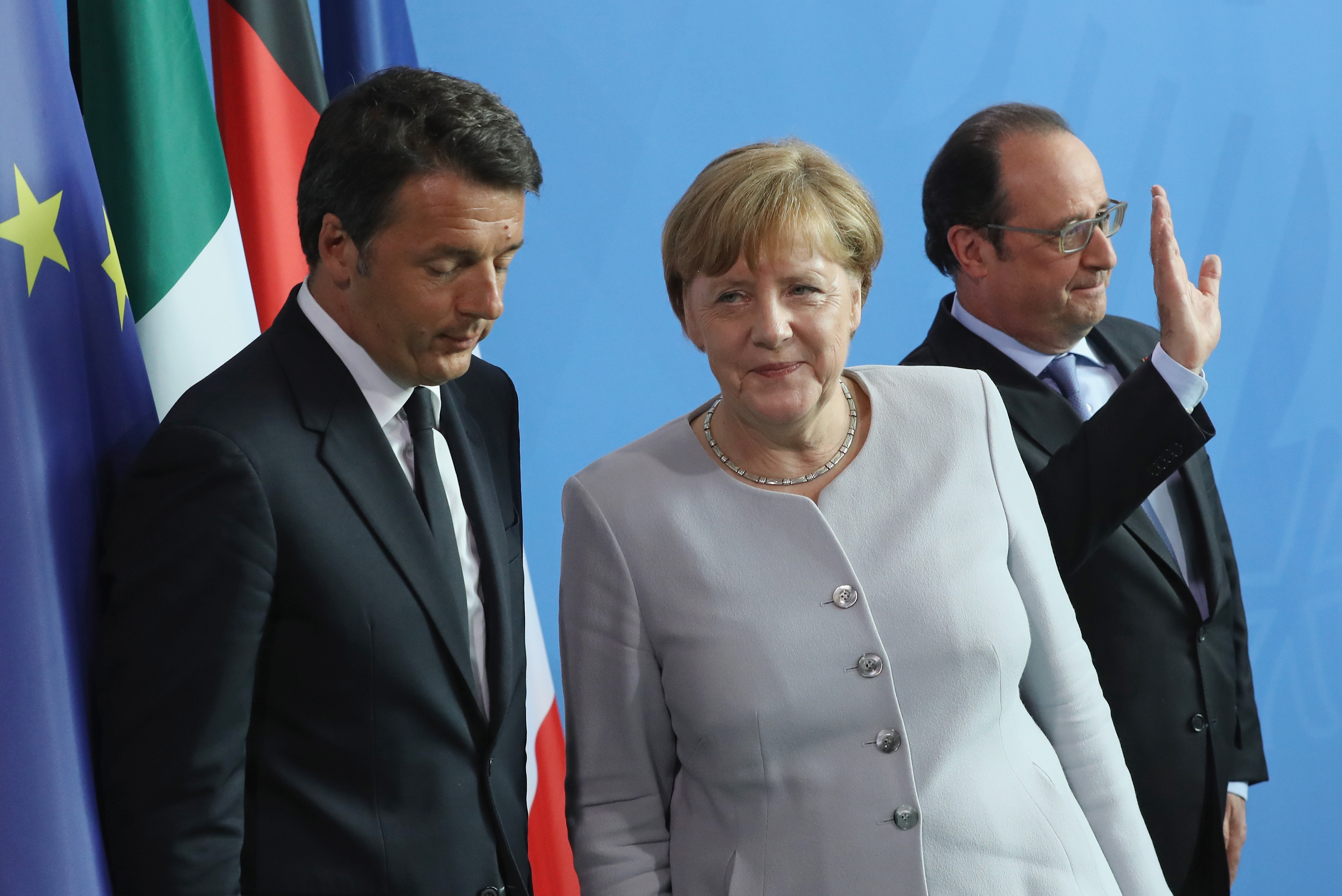 German Chancellor Angela Merkel, French President Francois Hollande (R) and Italian Prime Minister Matteo Renzi depart after speaking to the media during talks at the Chancellery on June 27, 2016 in Berlin. (Sean Gallup—Getty Images)
