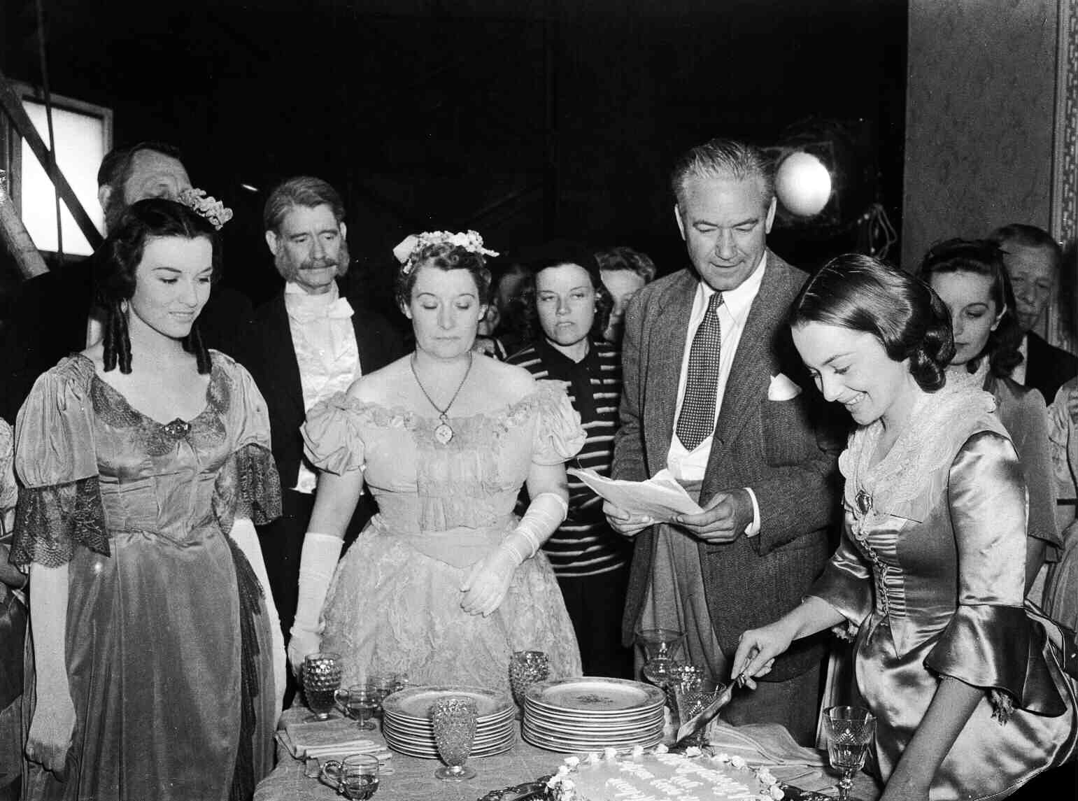 Victor Fleming, second from right, and Olivia de Havilland, right, on the set of Gone with the Wind in 1939.