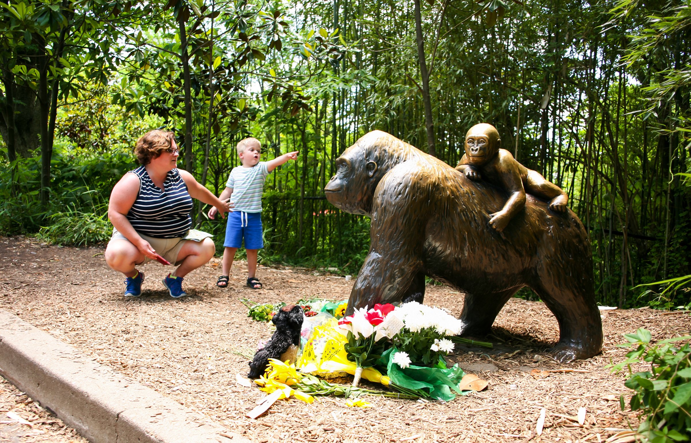A mother and her child visit a bronze statue of a gorilla outside the Cincinnati Zoo's Gorilla World exhibit, two days after officials were forced to kill Harambe, a Western lowland gorilla, in Cincinnati, May 30, 2016.
