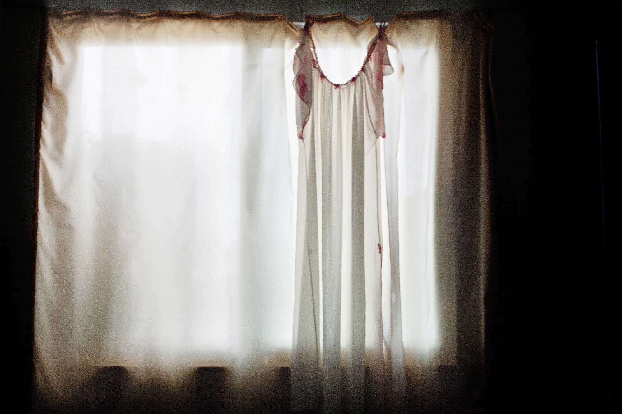 Nadia, 25, lives with 17 displaced family members in a two-bedroom apartment. Above, hangs her mother-in-law’s lingerie, one of her only intimate items smuggled from Syria, which she offered to share with Nadia if her son returns from the front lines.