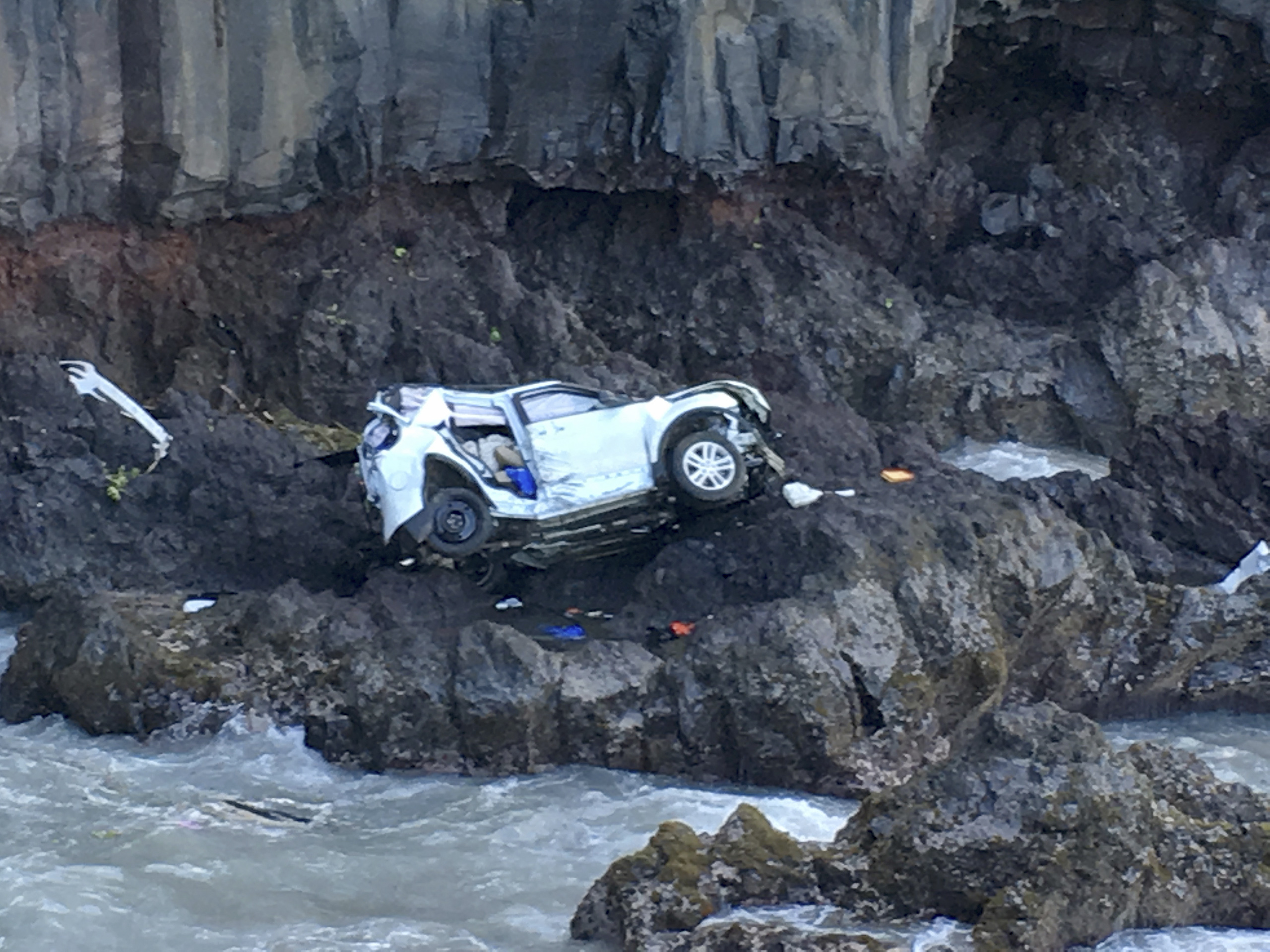 In this May 29, 2016, photo provided by Tom Johnson, a vehicle sits at the bottom of a cliff off Maui’s Hana Highway in Hana, Hawaii. Police say the Ford Explorer fell about 200 feet. Prosecutors say Alexandria Duval, who is also known as Alison Dadow, intentionally caused the death of her sister, Anastasia Duval, also known as Ann Dadow. (Tom Johnson—AP)