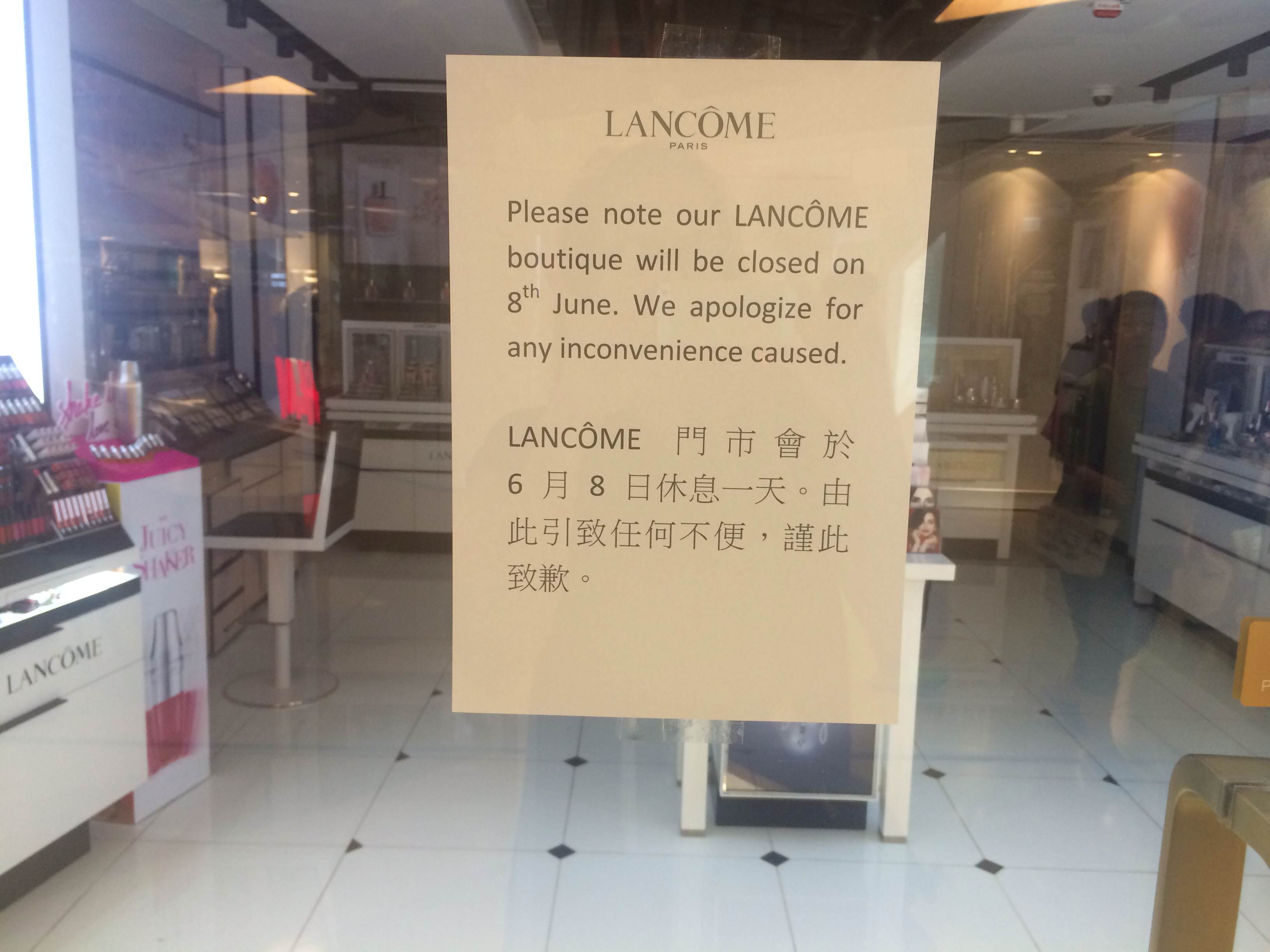 A sign on the store doors of Lancome at Cityplaza in Hong Kong advises customers that the store has been temporarily closed (Amanda Calvo)