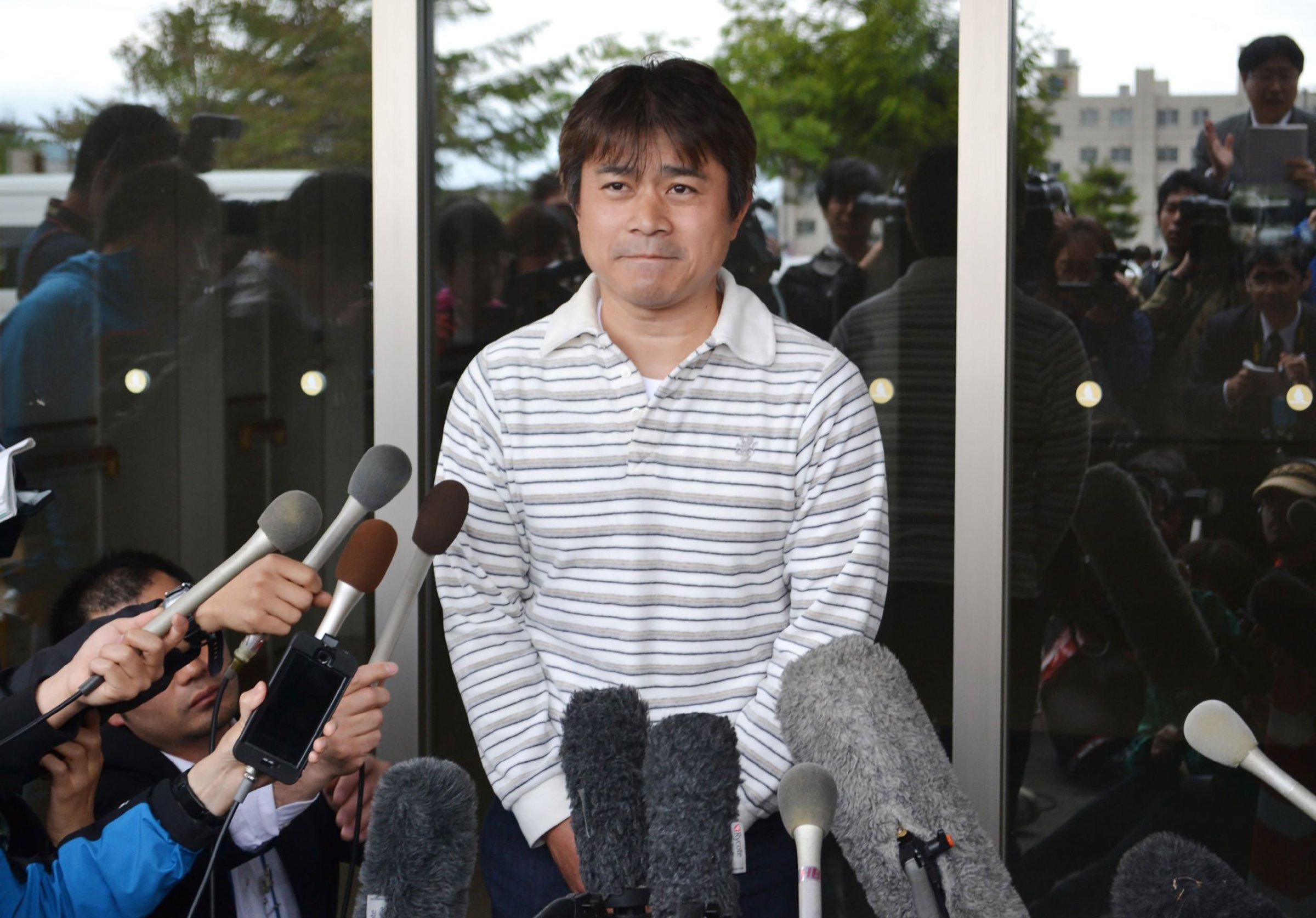 Father of Yamato Tanooka, a seven-year-old boy missing since being abandoned in a bear-inhabited forest in northern Japan, speaks to reporters in Hakodate on June 3, 2016.