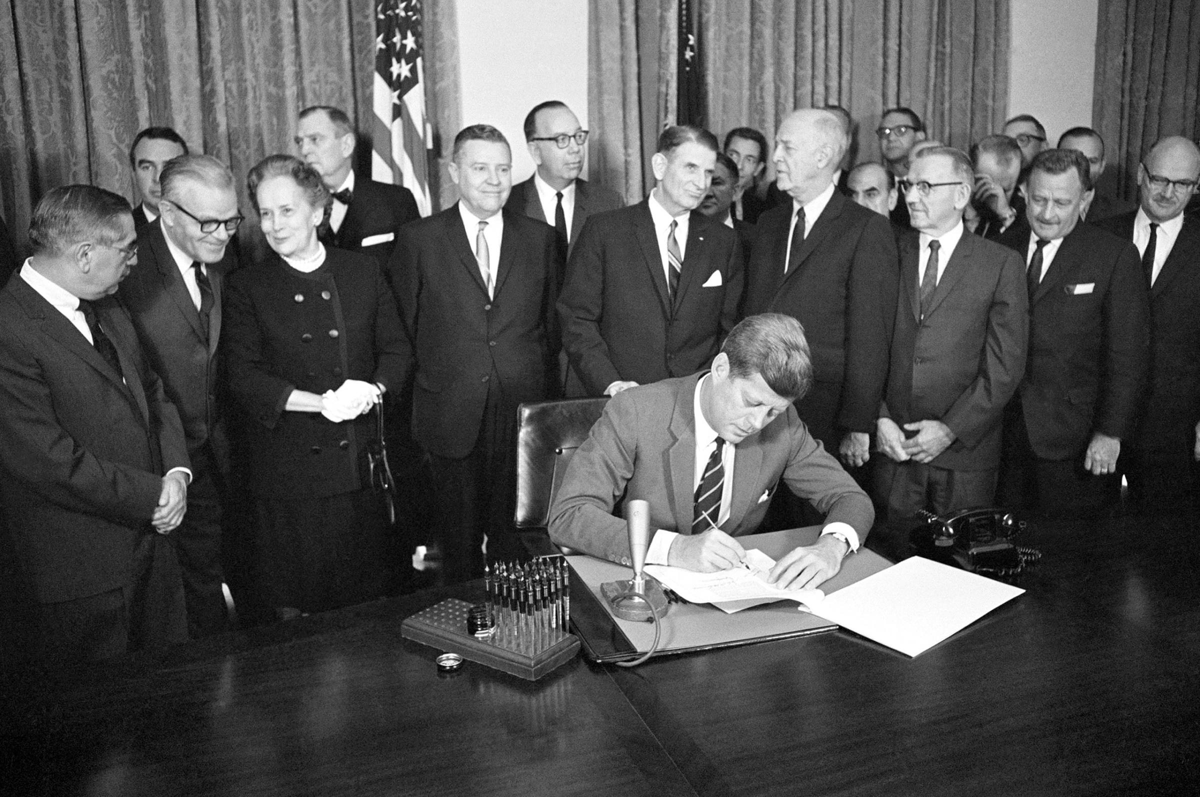 President John F. Kennedy signs a bill authorizing $329 million for mental health programs at the White House in Washington. October 31, 1963.