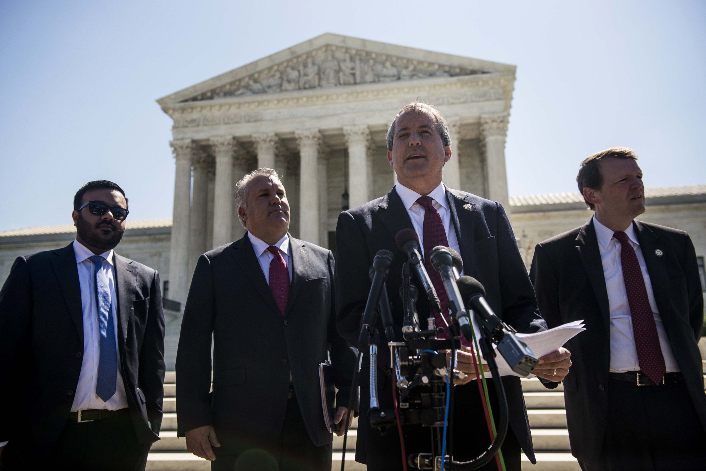 Texas Attorney General Ken Paxton speaks to reporters at a news conference outside the Supreme Court on Capitol Hill in Washington D.C. on June 9, 2016.
