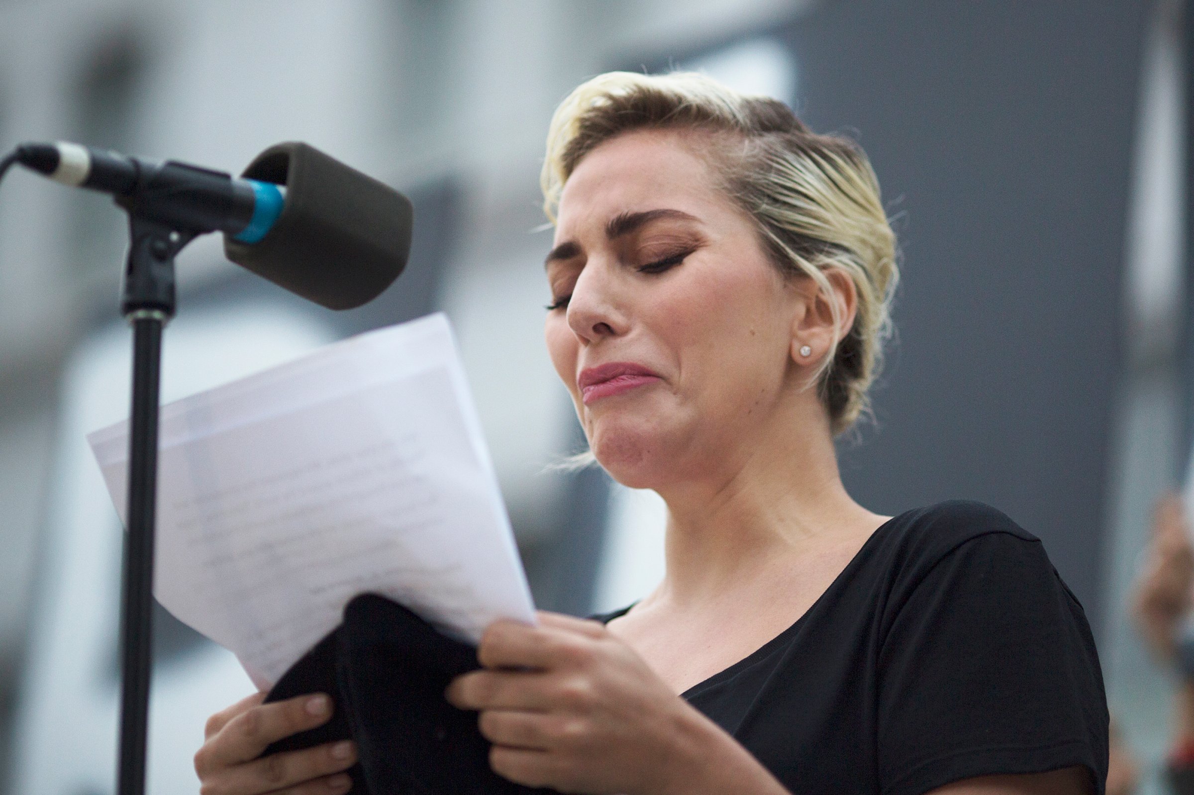 Lady Gaga reads some of the names of the victims of the Orlando shooting at a vigil on June 13, 2016 in Los Angeles.