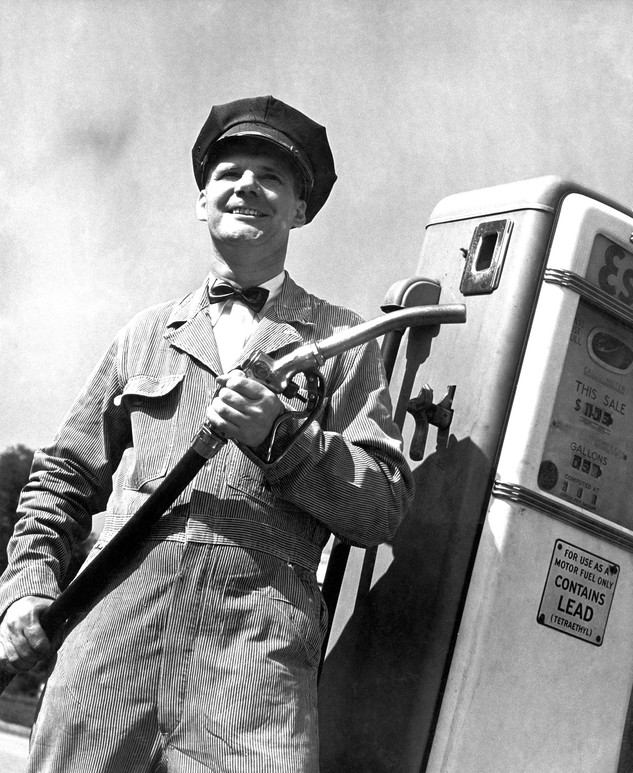 A gas pump attendant at the ready with leaded gas, circa 1955.