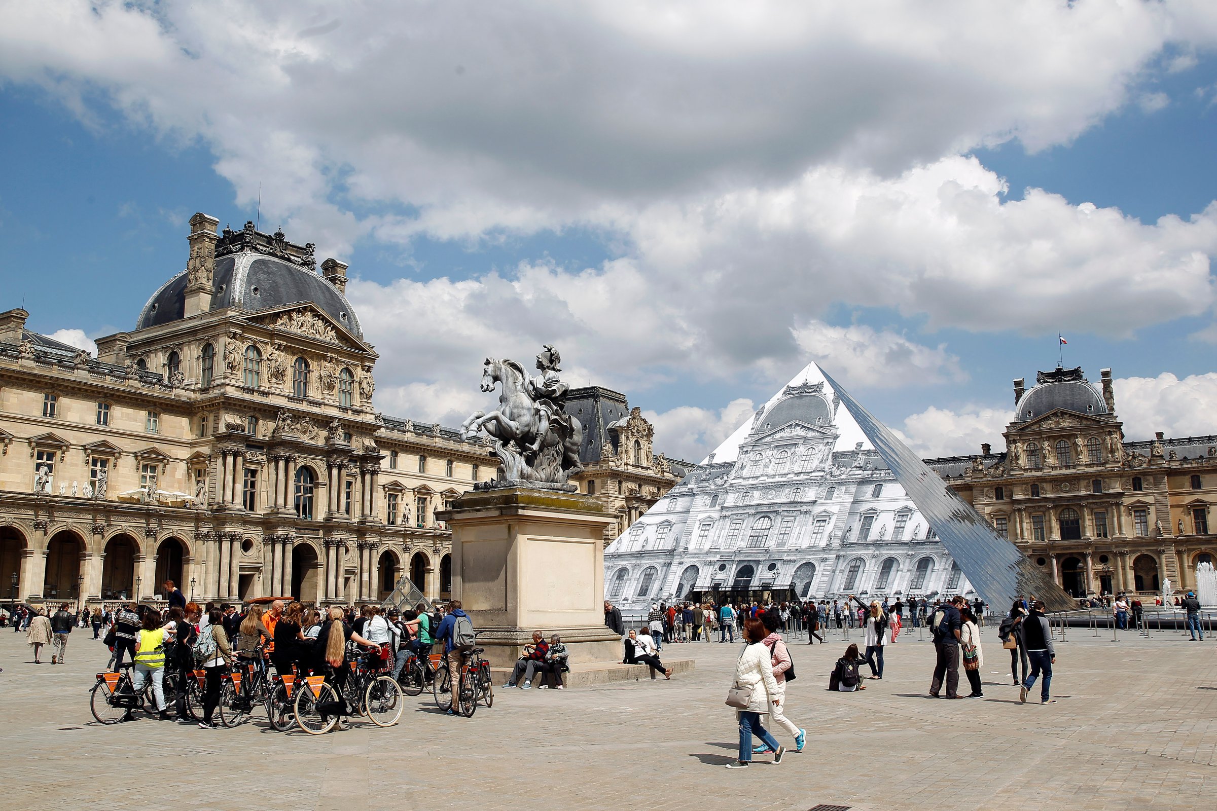 Artwork of French street artist and photographer JR is displayed on the Louvre Pyramid in Paris, May 25, 2016.