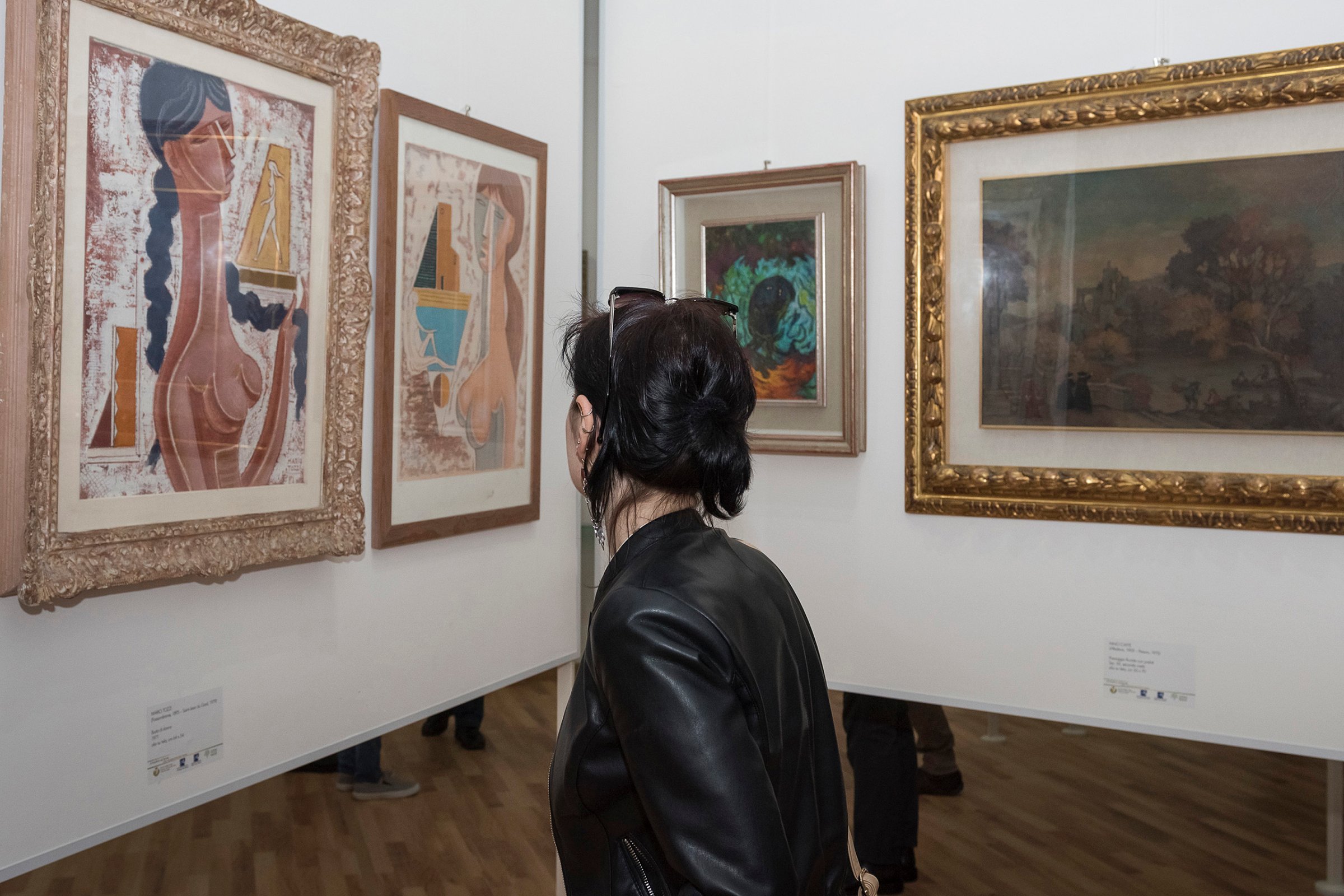 A visitor admires paintings during the "Victory of the State" exhibition in Reggio Calabria, Italy, on May 7, 2016. The exhibition includes paintings that belonged to a boss of the 'Ndrangheta Calabrese mafia, notably two of Dali, and were confiscated by the court.