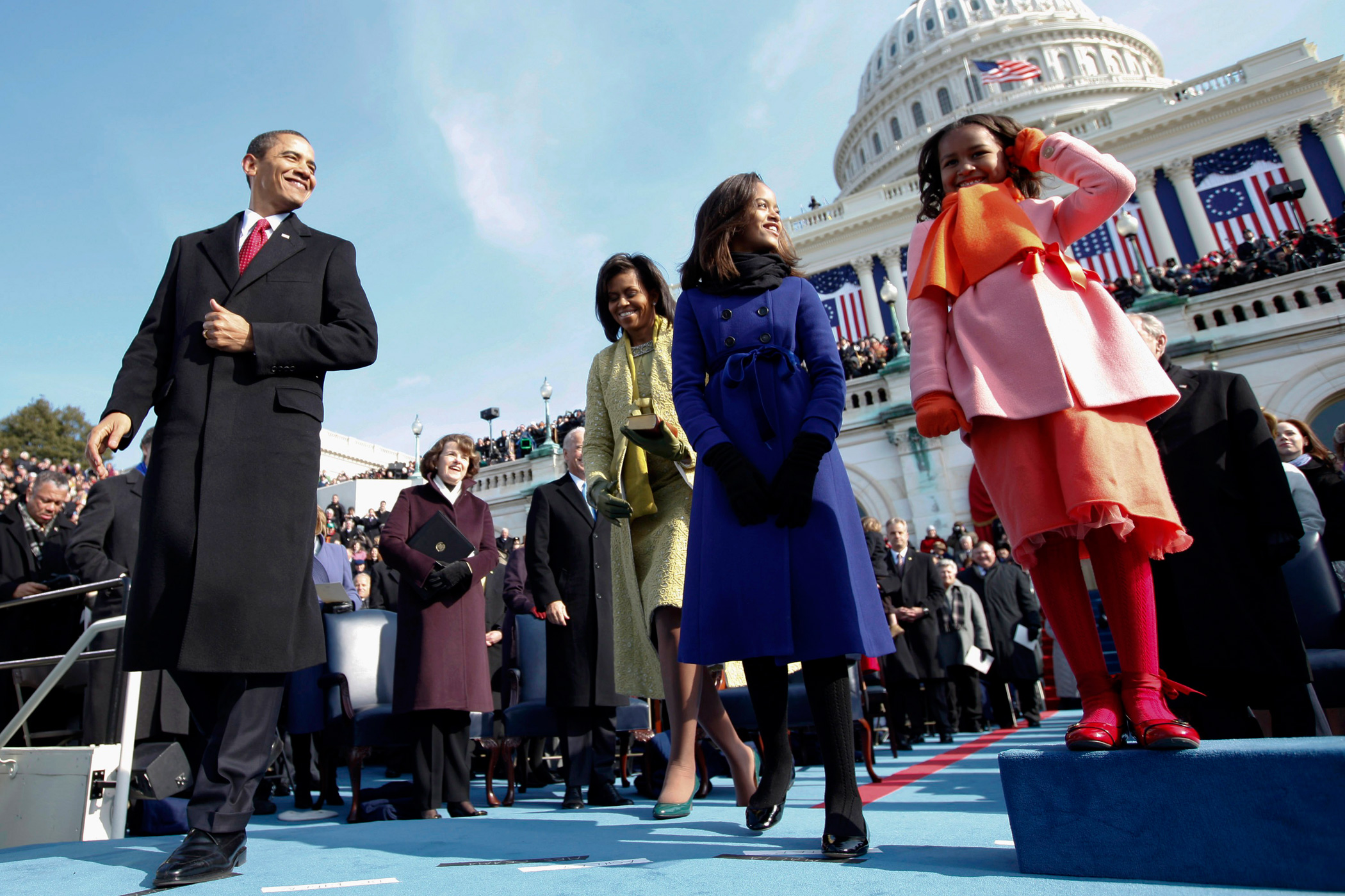 Malia Obama is graduating from the private Sidwell Friends School on Friday, growing up in the public eye of the White House. Jan. 20, 2009 Then President-elect Barack Obama, his wife Michelle and daughters Sasha, right and Malia, on the podium moments before Obama was sworn in as the 44th president at the U.S. Capitol in Washington. Malia, 10, wore a double-breasted periwinkle-blue coat with a blue-ribbon bow at the waist from Crewcuts by J. Crew.
