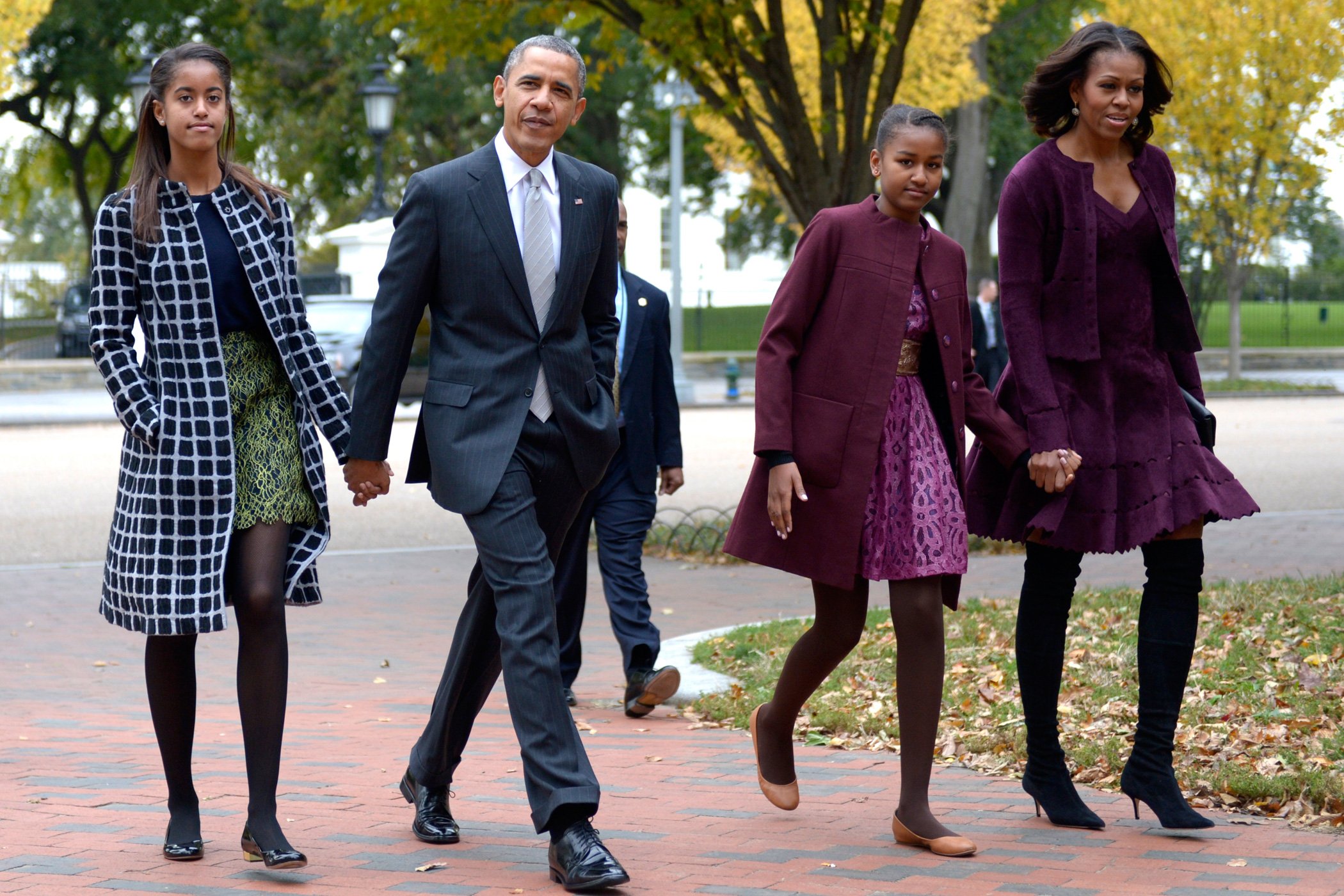 Oct. 27, 2013 President Barack Obama walks with his wife Michelle Obama and daughters Malia Obama and Sasha Obama through Lafayette Park to St John's Church to attend service in Washington.
