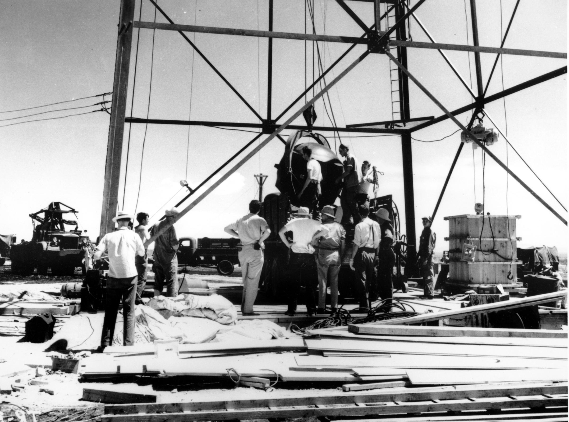 Scientists and workmen rig the world's first atomic bomb to raise it up into a 100-foot tower at the Trinity bomb test site in the desert near Alamagordo, N.M. in July 1945. The first atomic bomb test, known as the Manhattan Project, took place on July 16.