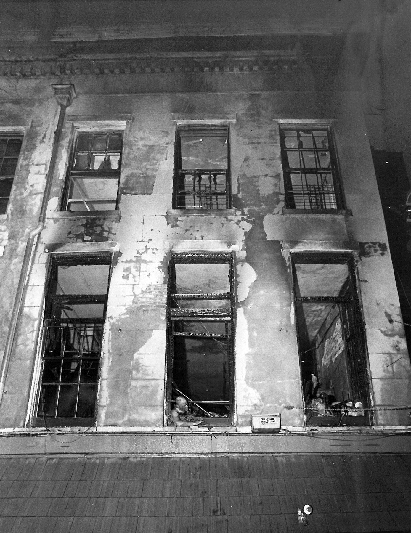 The MCC Rev. Bill Larson tried to push an air-conditioning unit out one of the windows to make an escape route between the bars. He was halfway out when the windowpane above fell and trapped him. His mannequin-like corpse remained in the window for hours after the fire. Thirty-two people were killed.