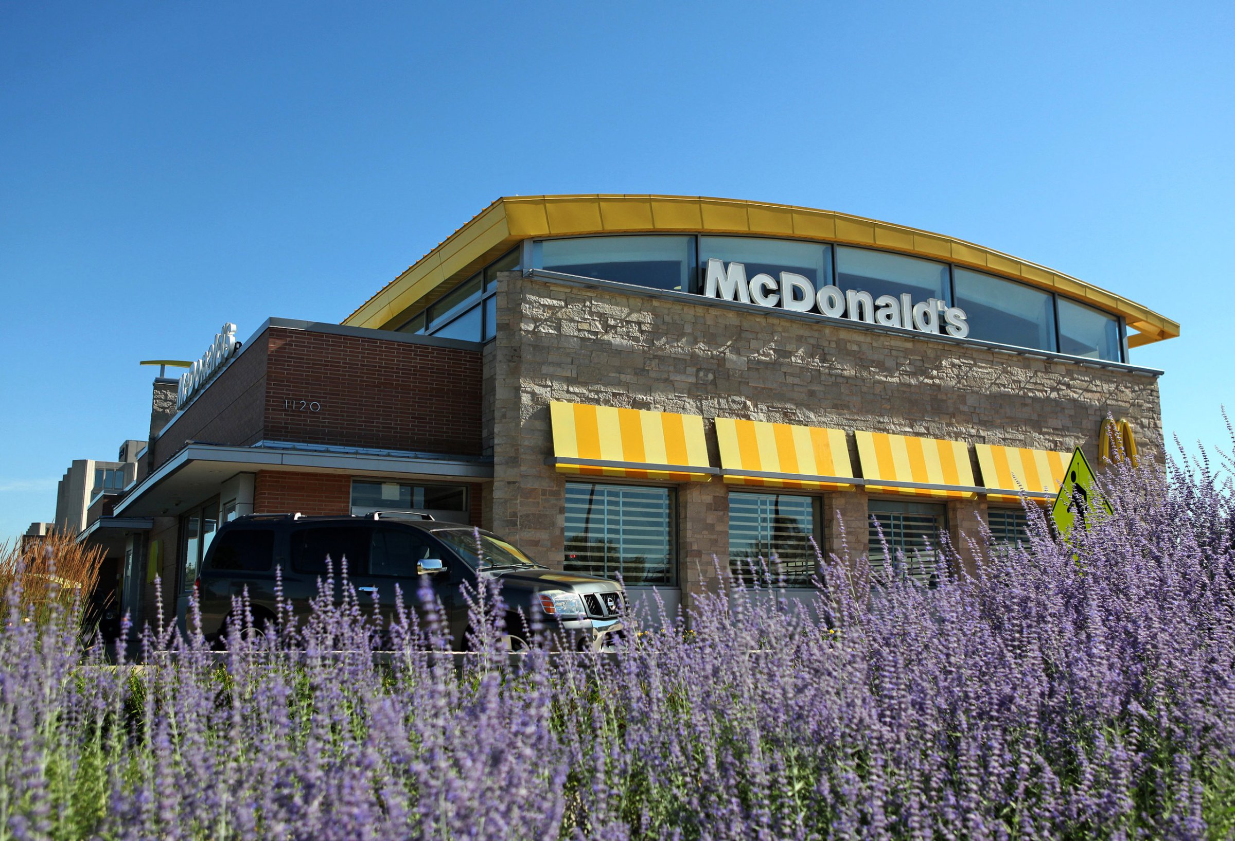 A car passes in front a McDonald's Corp. restaurant in Oak Brook, Illinois, U.S., on July 12, 2013.
