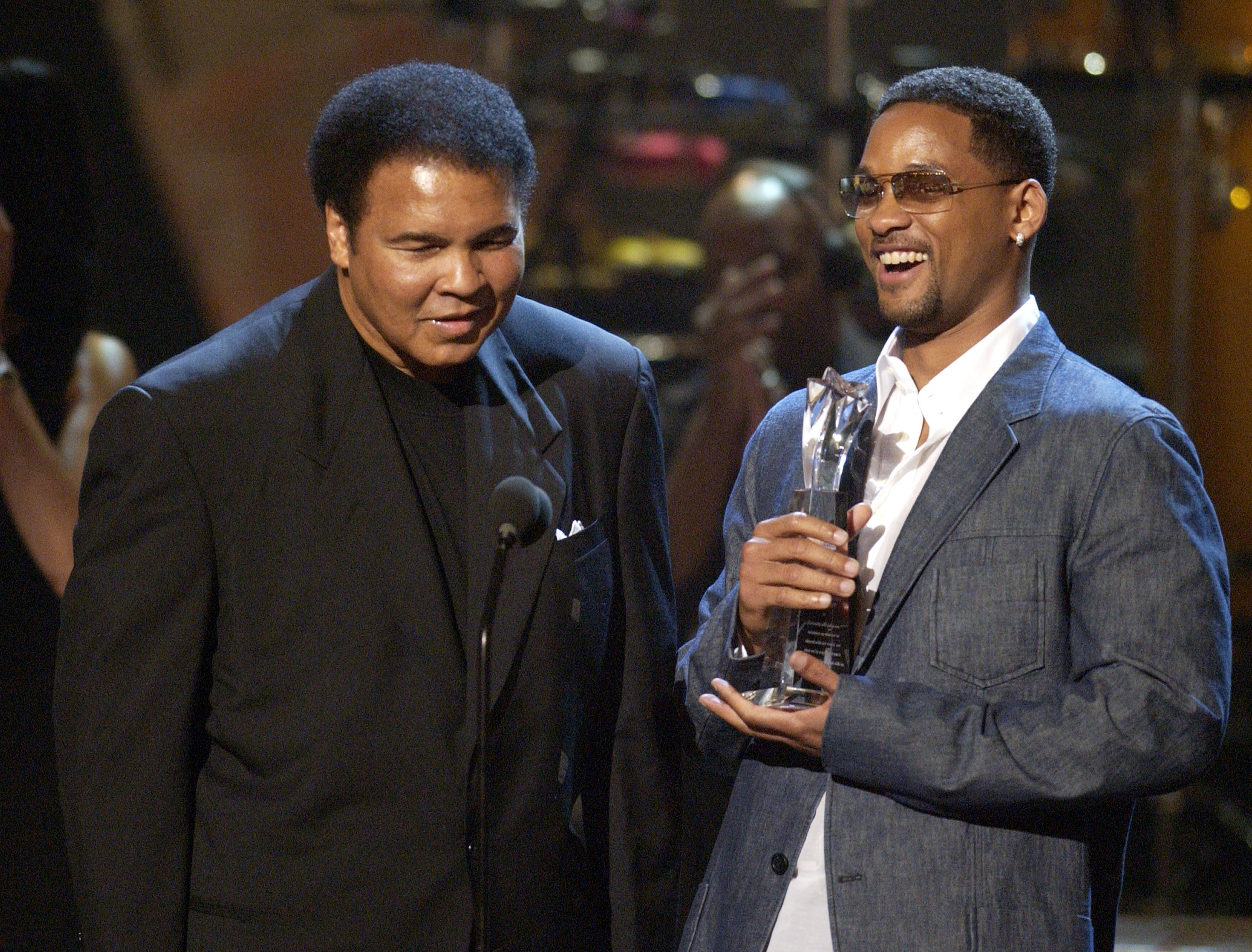 Muhammad Ali accepting his Humanitarian Award from presenter Will Smith during the 2nd annual BET Awards in Los Angeles on June 25, 2002. (Michael Caulfield Archive—WireImage/Getty Images)