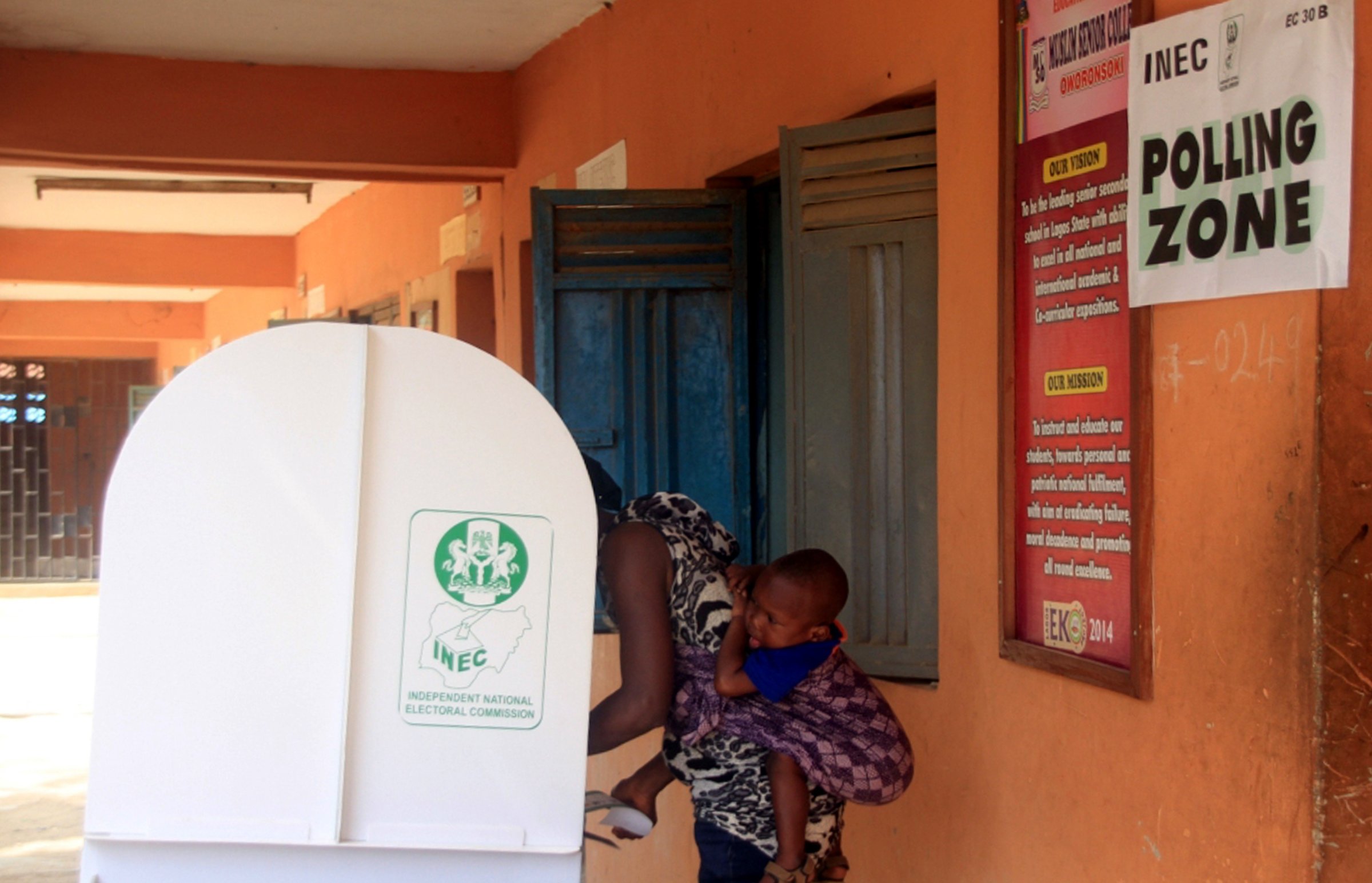 A voter carrying her baby on her back is seen in a polling booth in the city of Lagos, Nigeria on March 29, 2015.