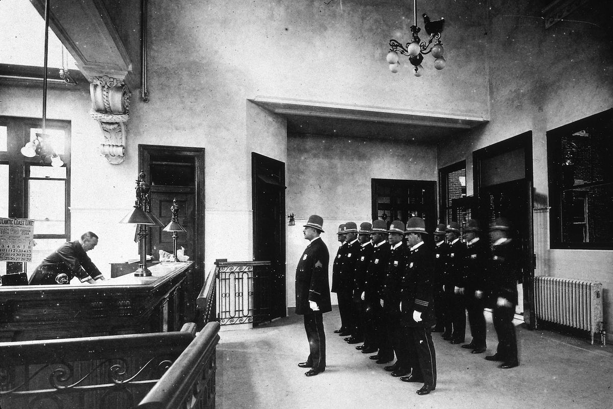 Uniformed police stand to attention behind their sergeant in a New York Police Department roll call, circa 1900 (MPI / Getty Images)