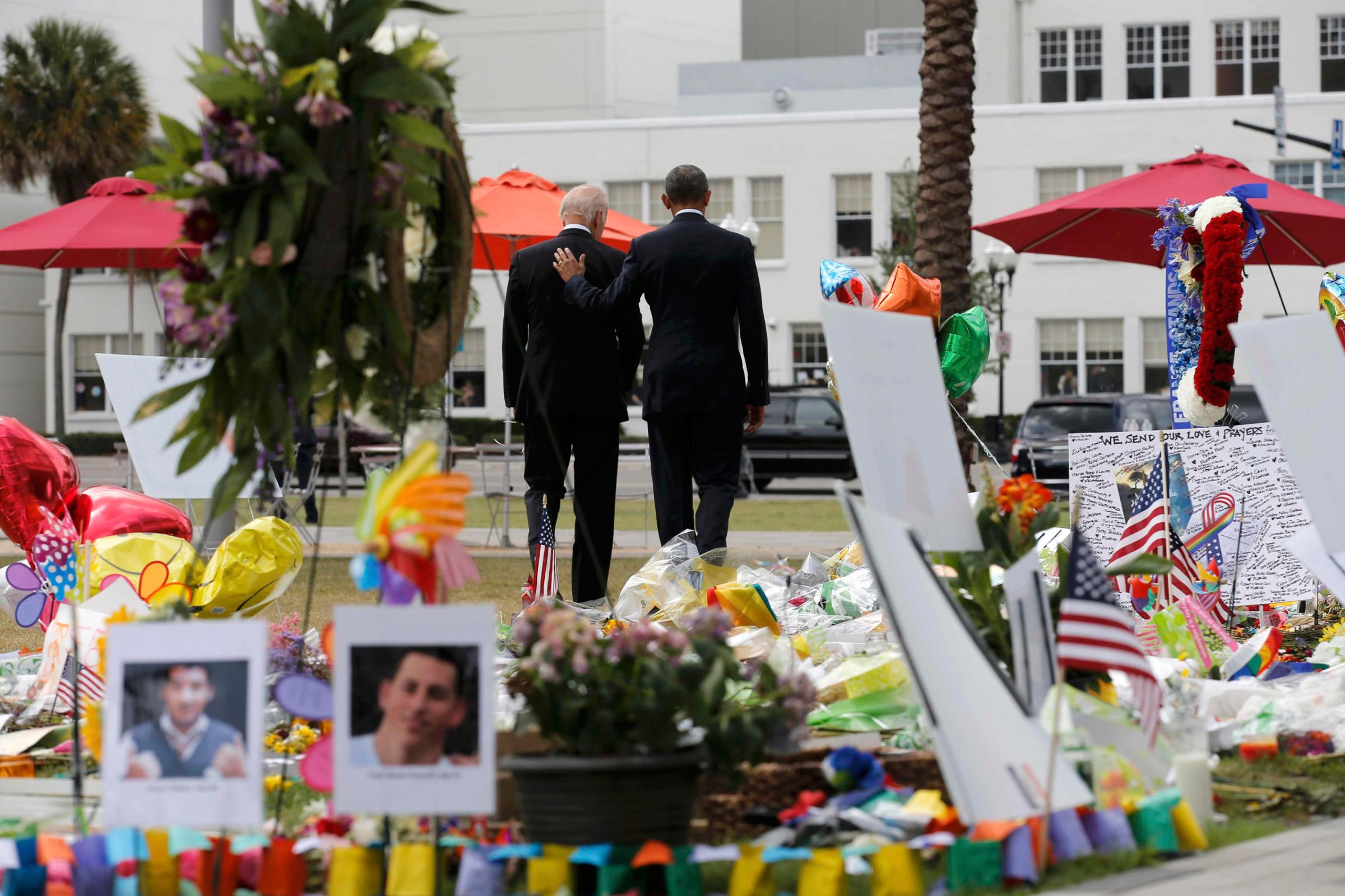 U.S. President Barack Obama (R) and Vice President Joe Biden depart a makeshift memorial after placing flowers in memory of shooting victims of the massacre at a gay nightclub in Orlando, Florida, U.S., June 16, 2016. REUTERS/Carlos Barria -TPX IMAGES OF THE DAY