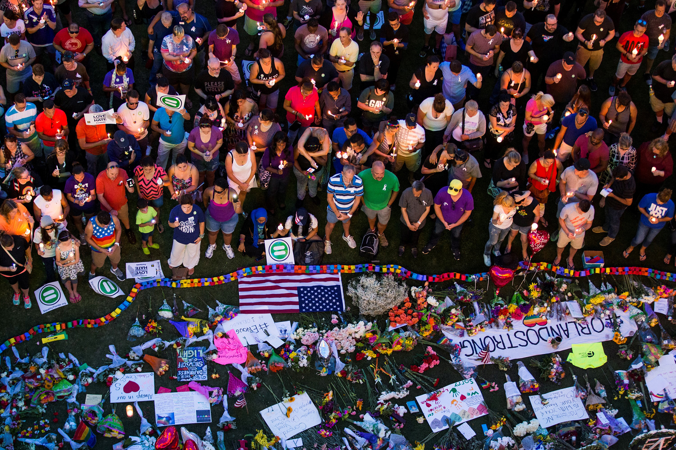 Thousands gather at the Dr. Phillips Center for the Performing Arts to pay their respects for those lost in the Pulse nightclub shooting in Orlando, Fla., on June 13, 2016. (Samuel Corum—Anadolu Agency/Getty Images)