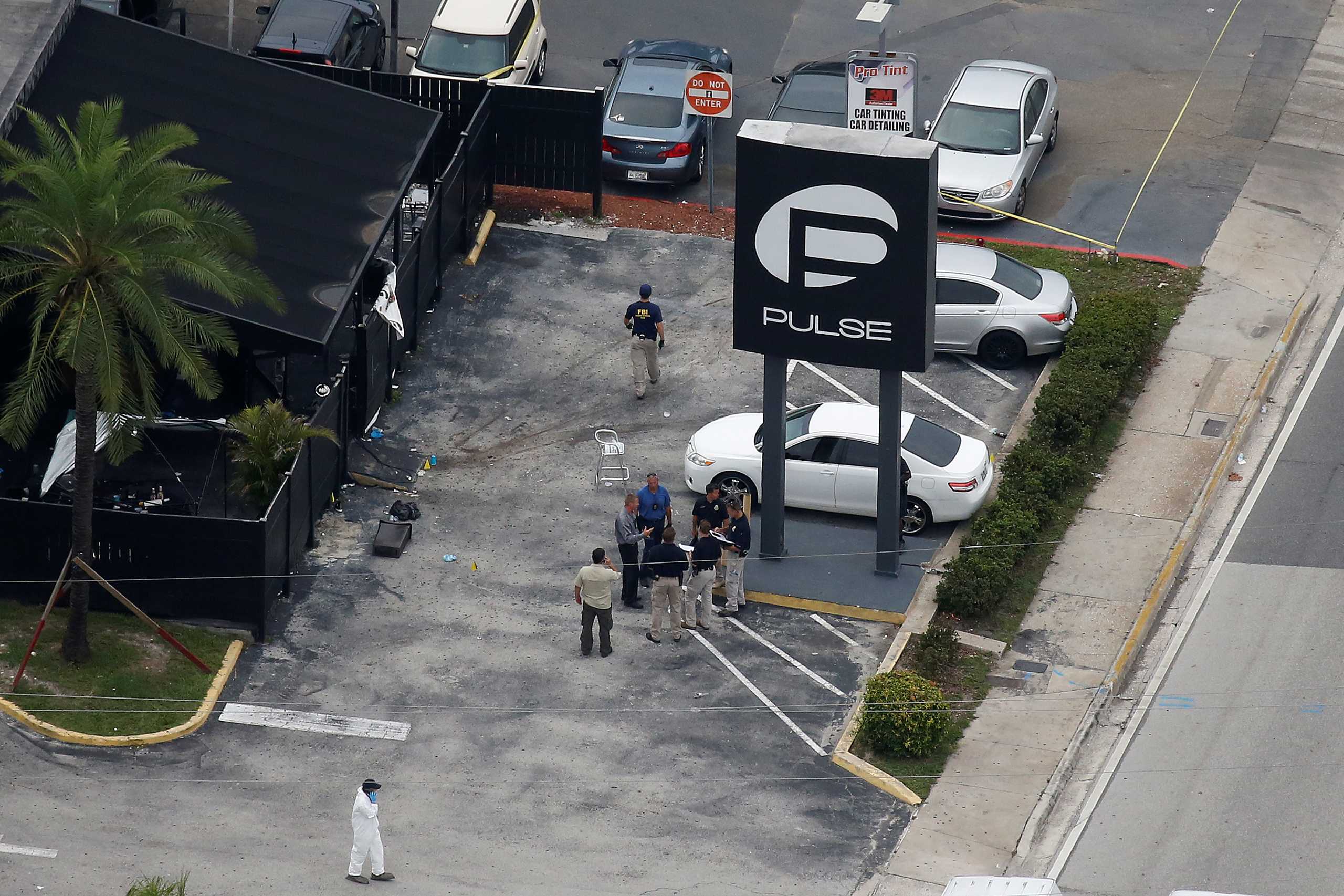 Investigators work the scene following a mass shooting at the Pulse gay nightclub in Orlando, Fla., on June 12, 2016. (Carlo Allegri—Reuters)