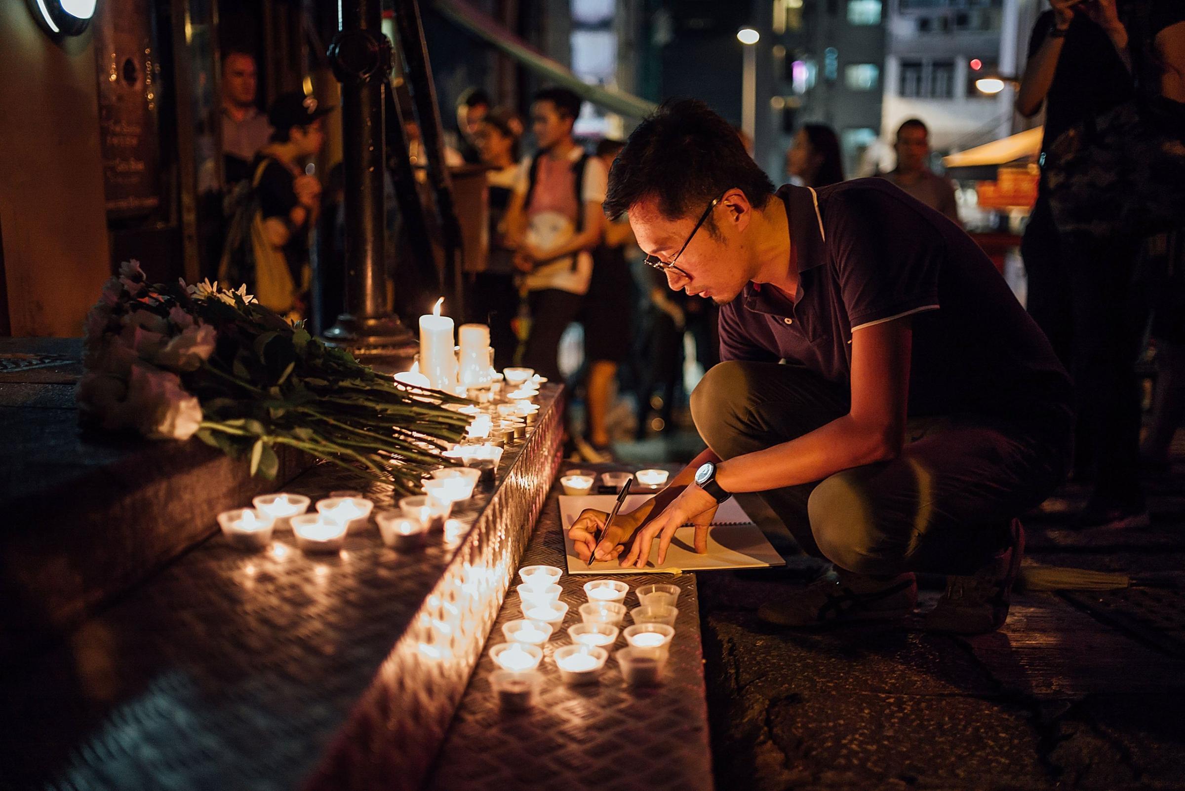 People take part in a candlelight vigil for the victims of a shooting in a gay nightclub in Orlando, Florida in Hong Kong, Hong Kong on June 13, 2016.