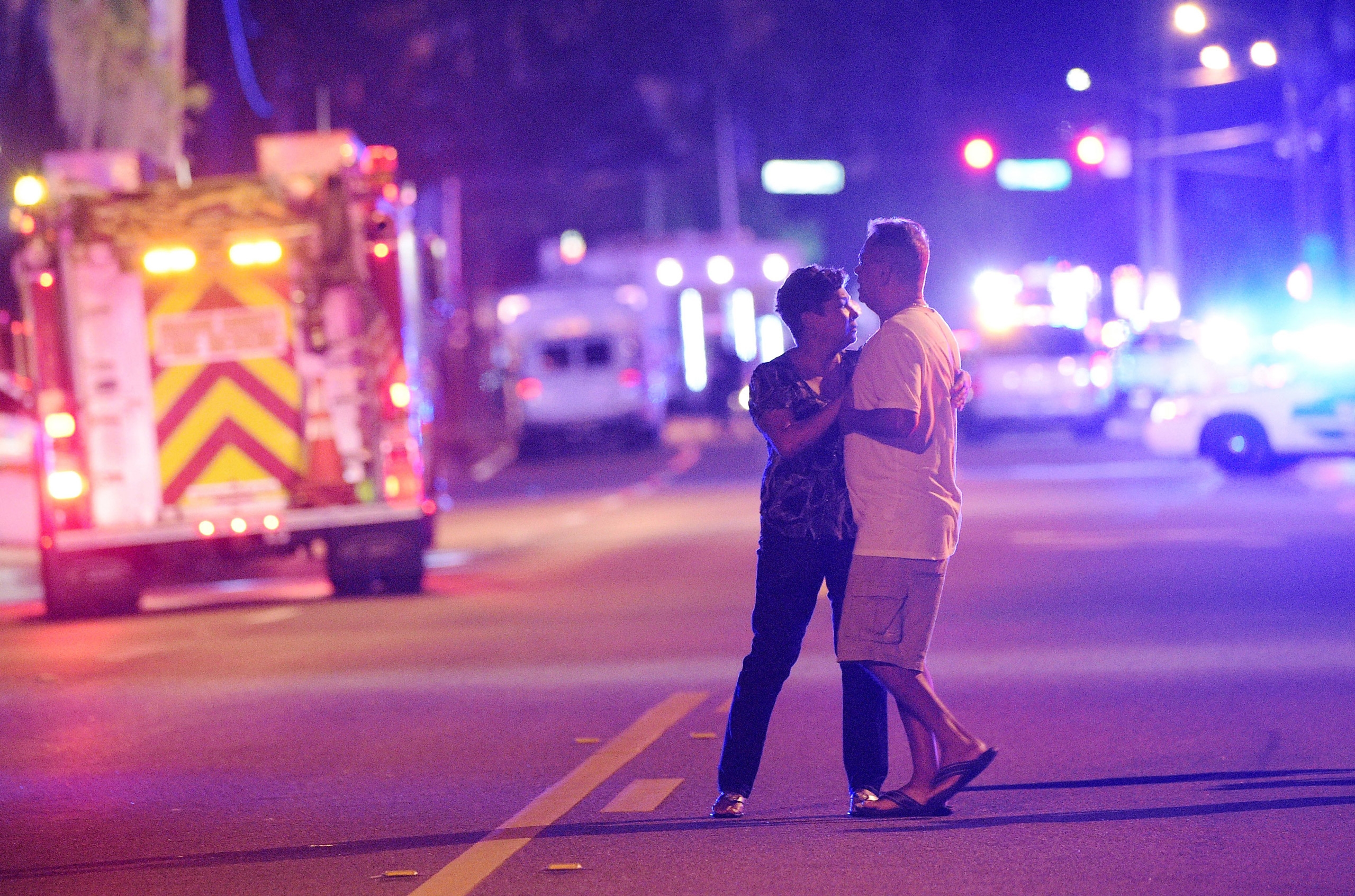 Family members wait for word from police after arriving down the street from a shooting involving multiple fatalities at Pulse Orlando nightclub in Orlando, Fla., Sunday, June 12, 2016. (AP Photo/Phelan M. Ebenhack) (Phelan M. Ebenhack&mdash;AP)