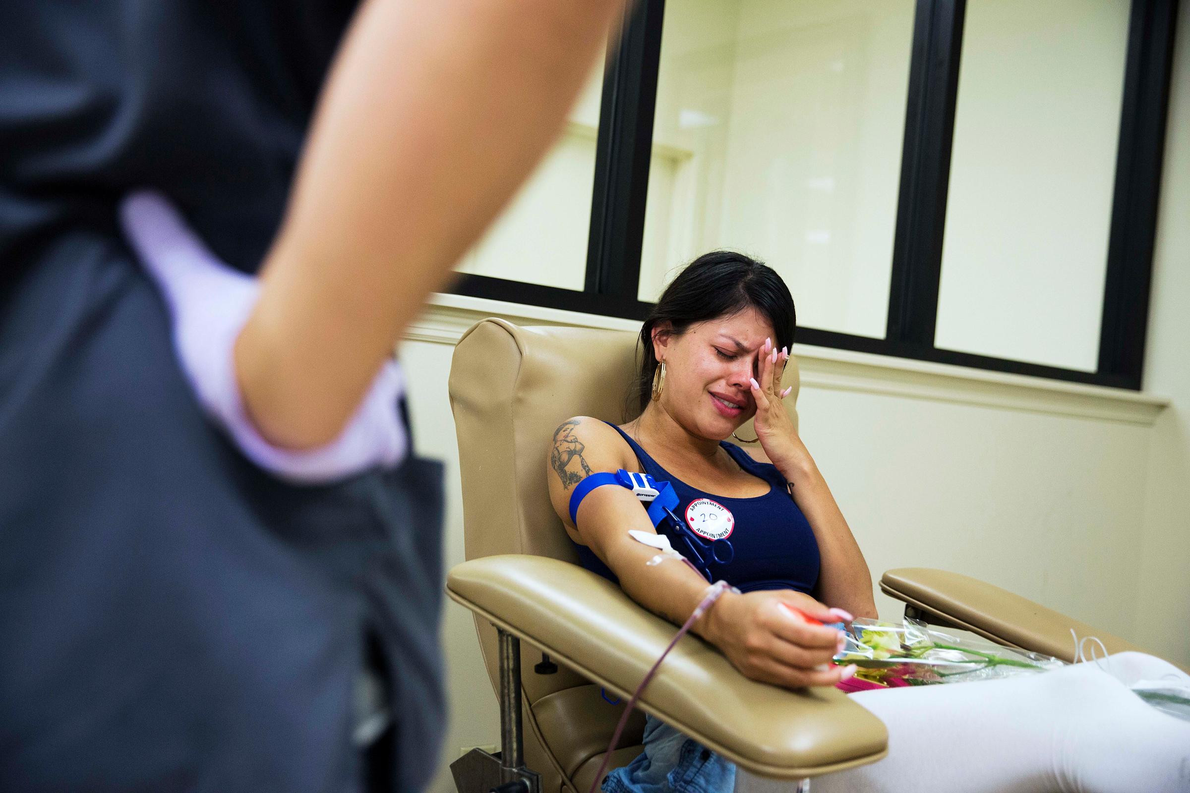 Tatiana Osorio cries while giving blood at the OneBlood blood center near the mass shooting at a nightclub in Orlando, Fla., on June 13, 2016. Osorio lost three friends in the shooting.