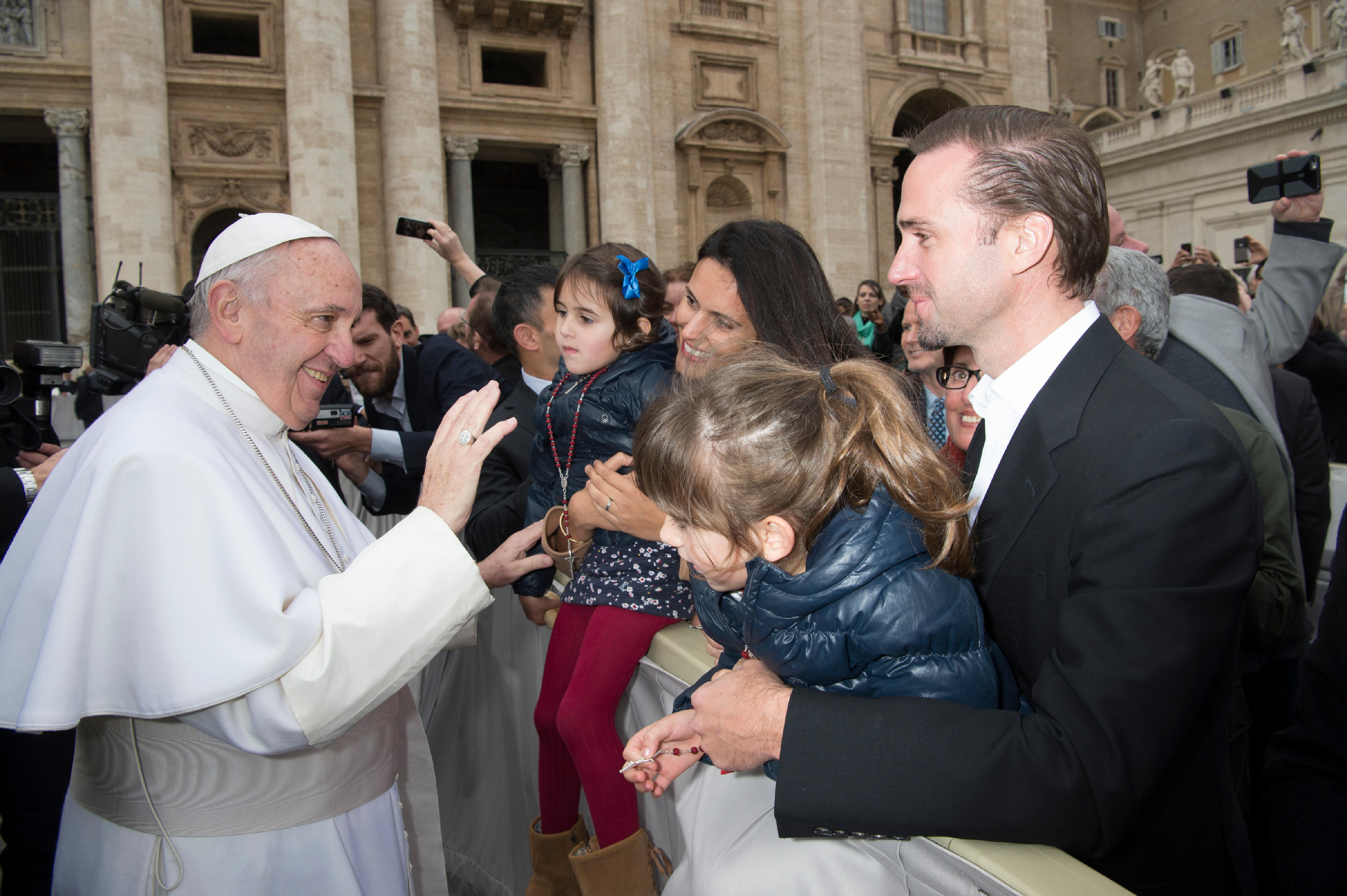 Joseph Fiennes, right, and his wife Maria Dolores Dieguez hold their two daughters as they greet Pope Francis at the Vatican on Feb. 3, 2016.