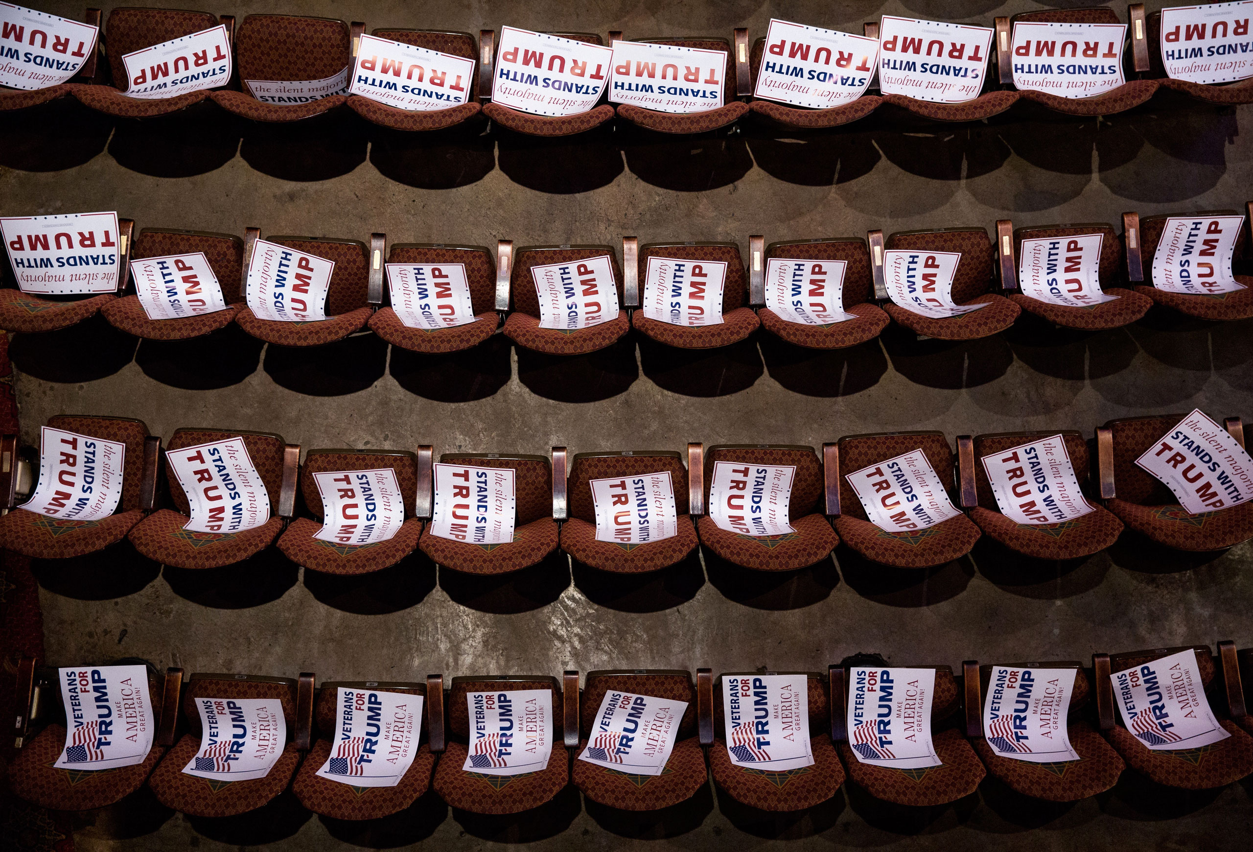 Campaign signs await attendees at a Trump rally at the Fox Theatre in Atlanta on June 15 (DAMON WINTER—The New York Times/Redux)