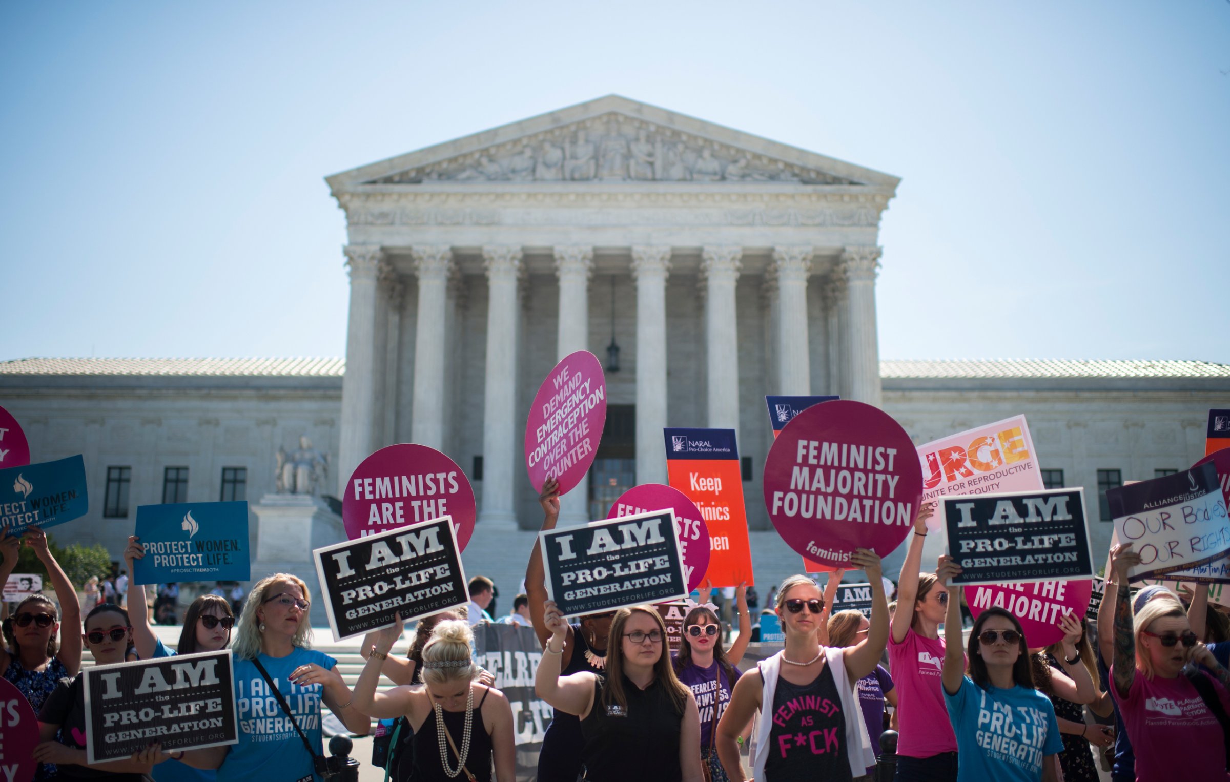 Pro-choice and pro-life demonstrators rally outside of the U.S. Supreme Court on Monday morning, June 20, 2016. The court is expected to hand down their decision on a Texas law which requires clinics to meet the same standards as ambulatory surgical centers and forces doctors to have admitting privileges at nearby hospitals. (Photo By Bill Clark/CQ Roll Call) (CQ Roll Call via AP Images)