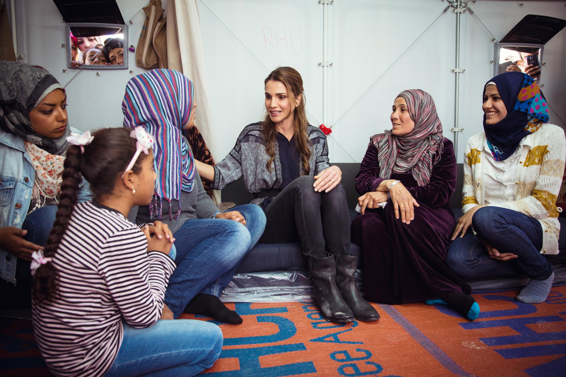 In this handout image supplied by the Office of Her Majesty Queen Rania Al Abdullah, Royal Hashemite Court, Queen Rania of Jordan meets Syrian refuges at the Karatepe municipality camp for refugees on the outskirts of Mytilene in Lesbos, Greece on April 25, 2016.