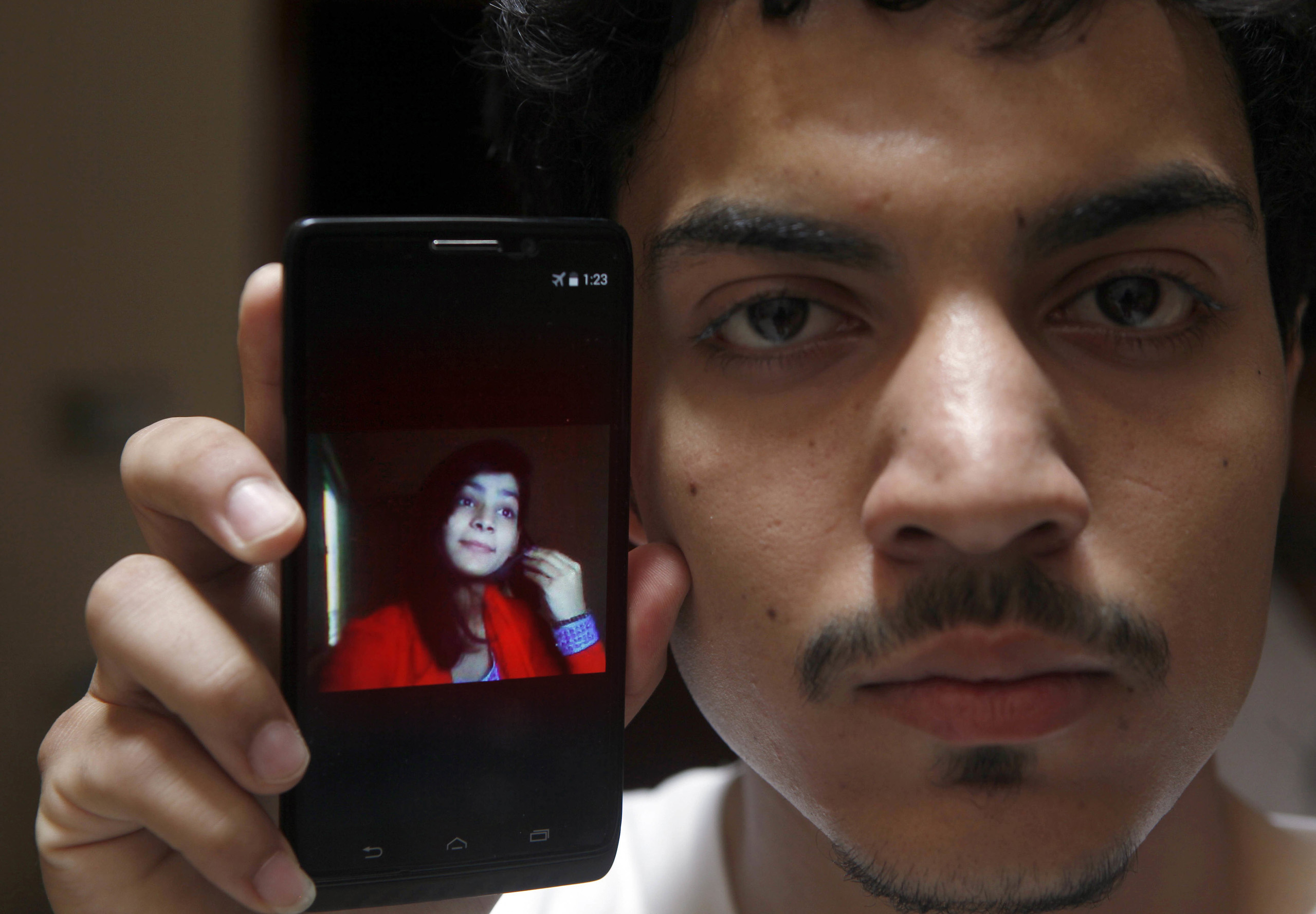 Hassan Khan shows the picture of his wife Zeenat Rafiq, who was burned alive, allegedly by her mother, at his home in Lahore, Pakistan, June 8, 2016. (K.M. Chaudary—AP)