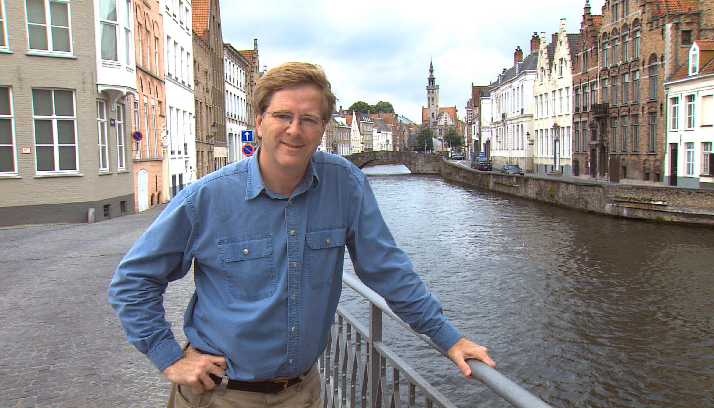 Rick Steves, in Bruges, Belgium: He spends July and August north of the Alps.
